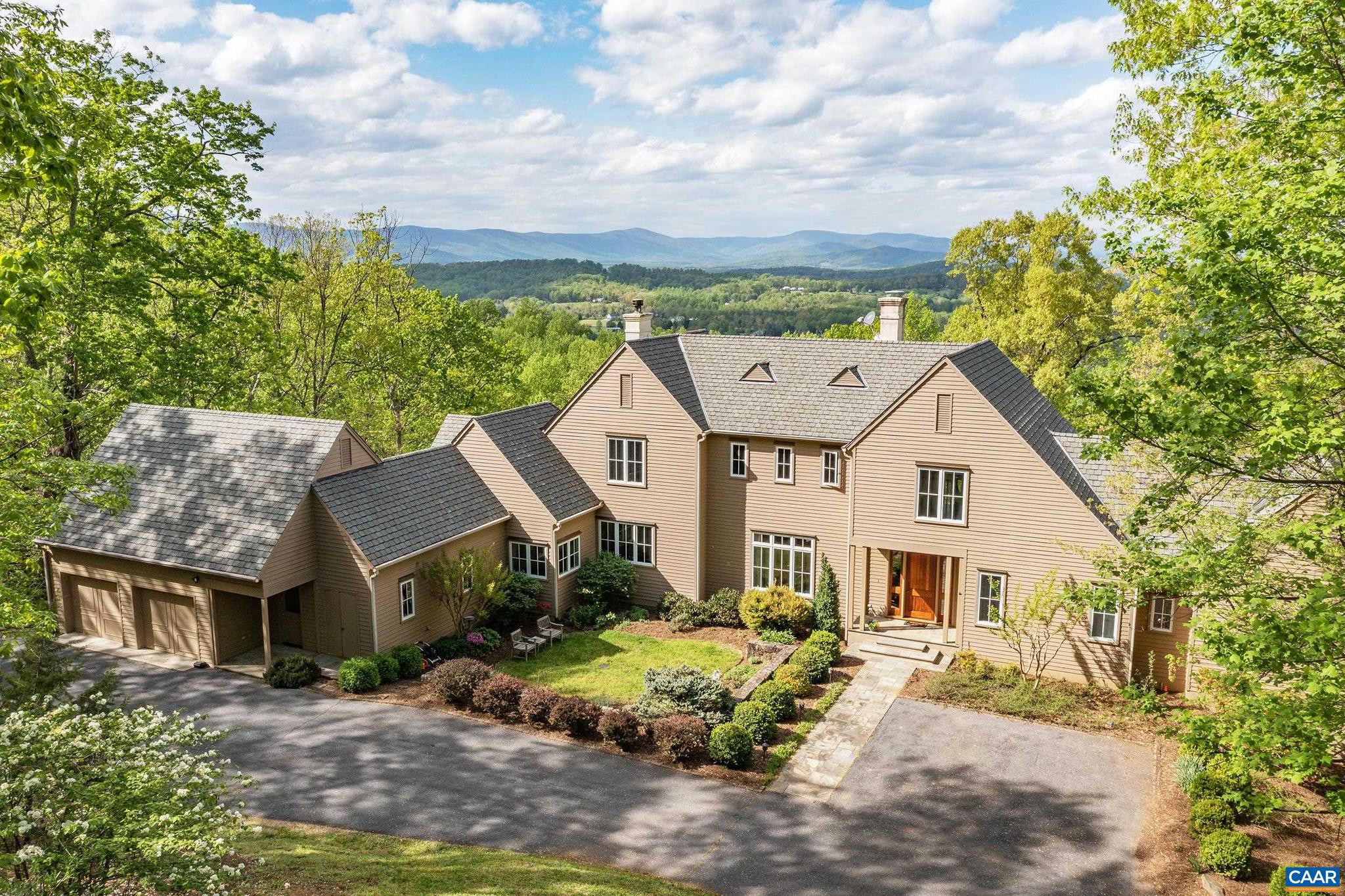 Panoramic views of the Blue Ridge Mountains & Albemarle County - all the way into Greene County from 1,000 ft. elevation - in the coveted Rosemont neighborhood - less than 15 minutes to UVA & Charlottesville. Dramatic residence with over 5,000 fin.sq.ft. has been very well maintained and includes new HVAC, new water heaters & new appliances. Entire exterior just painted. Interior features: a main level master suite; home office; 10 ft. ceilings; beautiful heart pine floors; well-equipped kitchen with white cabinets and a beautiful granite; adjoining breakfast room with stone fireplace that flows out to a screened porch and spacious open deck to enjoy the SPECTACULAR VIEWS! There are two more levels - two bedrooms and hall bath on the second level, and a walkout terrace level that includes a 4th bedroom, full bath, exercise room, utility & storage. The property contains over 11 acres, mostly wooded with a stream. This is a special offering situated in the Ragged Mountains with magnificent views, privacy & tranquility.,Granite Counter,White Cabinets,Wood Cabinets,Fireplace in Great Room,Fireplace in Kitchen