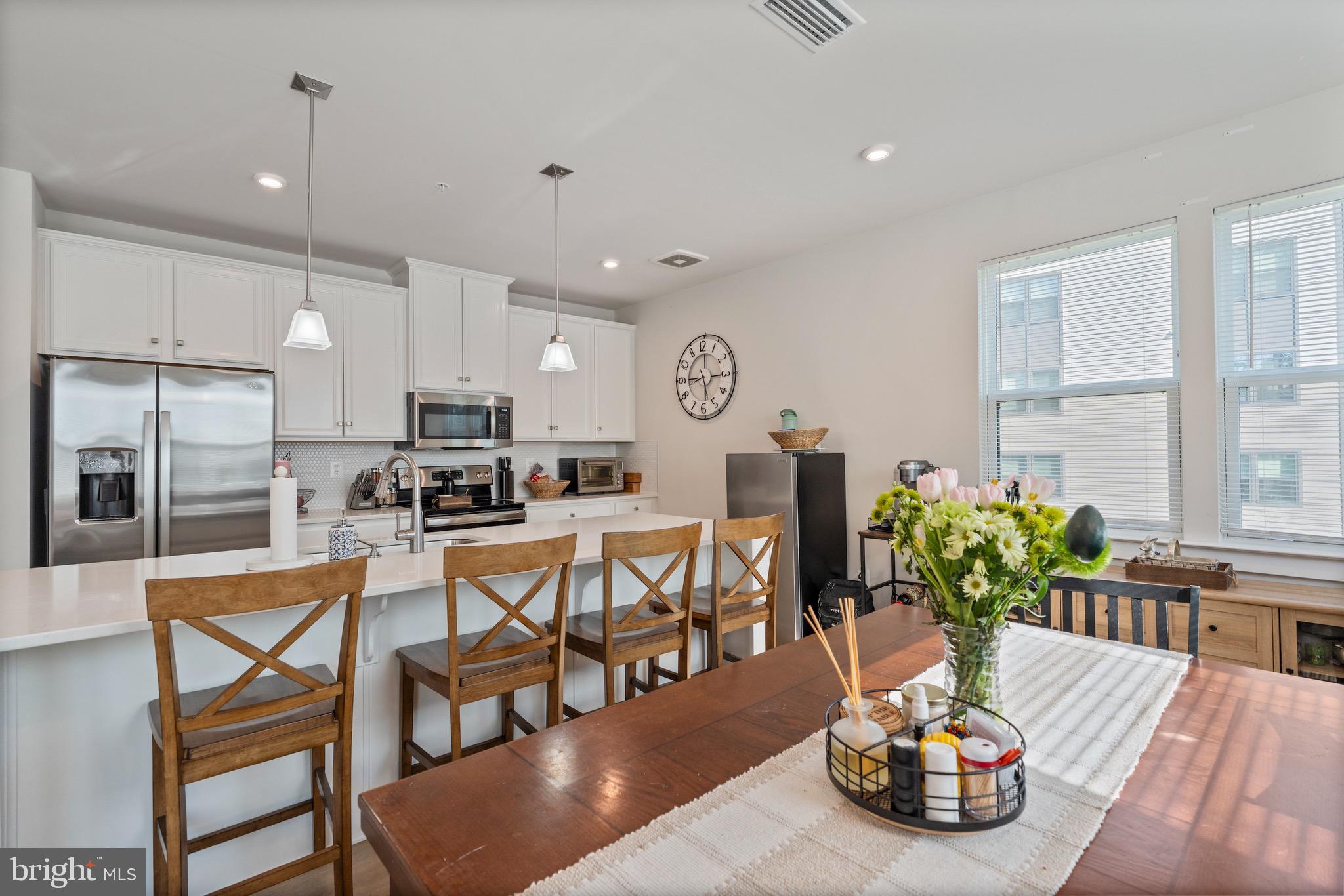 Welcome to this beautifully maintained condo offering the perfect blend of modern design and low-maintenance living. This light-filled unit features an open and airy layout with neutral finishes throughout and oversized windows that bring in natural light and serene wooded views.
The kitchen flows seamlessly into the main living space, creating an ideal setup for both everyday living and entertaining. Spacious bedrooms include a well-appointed primary suite with a dual vanity and walk-in closet, while the additional bedroom and full bath offer flexibility for guests, a home office, or additional living space. Enjoy the convenience of secure building access, ample parking, and a peaceful setting, all while being just minutes from shopping, dining, and major commuter routes. Ideal for those seeking comfort, convenience, and easy living in a well-maintained community.