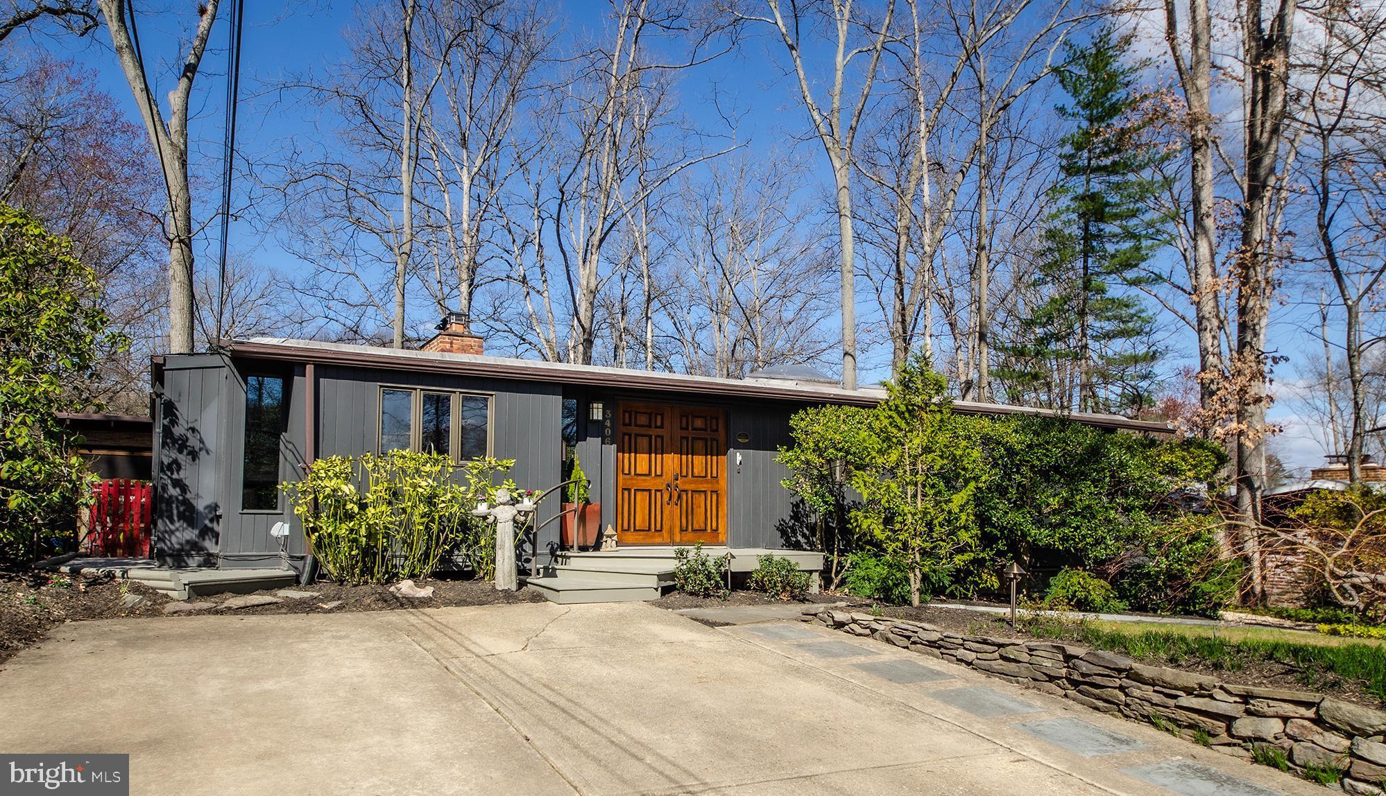 Calling All Mid-Century Modern Enthusiasts! This 2,550 sq ft home is sure to impress-thoughtfully expanded to offer modern amenities and additional living space while preserving the architectural integrity and open  aesthetic that make Mid-Century Modern homes so beloved by design purists. This expanded Luria model is nestled on a sprawling 10,727 sq ft lot, full of mature landscaping providing exceptional privacy and natural beauty. Situated in an extraordinarily serene and peaceful locale within the Holmes Run Acres neighborhood, this special home is just a 1 ½ block stroll from the beloved Luria Park and the vast adjoining Holmes Run Stream Valley Park, woodlands and nature trails.  Step in through the handsome wood double entry doors into a welcoming ceramic tile foyer, where glimpses of the stunning interior unfolds. The “Top Chef” worthy gourmet kitchen w/adjoining dining room addition has been seamlessly integrated, flowing into the reconfigured main level and outdoor living areas.  At the heart of the home, the iconic vaulted family room showcases signature Mid-Century Modern features such as stunning cedar beamed ceilings, warm exposed brick, a cozy wood burning stove, gleaming hardwoods, floating staircase, and a sweeping wall of windows. This thoughtfully designed home offers 4 bedrooms, 2 updated baths and oversized windows, all framed by extensive decking for uncomplicated indoor/outdoor living. The reimagined floor plan also includes a flexible bedroom configuration allowing for handy office, guest room or den options, perfect for today’s work from home lifestyle. The fully finished lower level provides a walkout rec room bathed in natural light, additional bedroom or office options, and abundant storage. Outside, the lush landscaping is complemented by a tranquil screened-in gazebo, relaxing patio, and terraced decking, all overlooking years of carefully curated gardens. The nearby Holmes Run Recreation Association offers 3 sparkling pools in a park-like setting complete with picnic areas, grills and a myriad of recreational activities. Enjoy the perfect blend of serenity and convenience with easy access to major transportation routes, I-495, and the vibrant Mosaic District. Come see why this commuter-friendly enclave is so popular with today’s homebuyers!