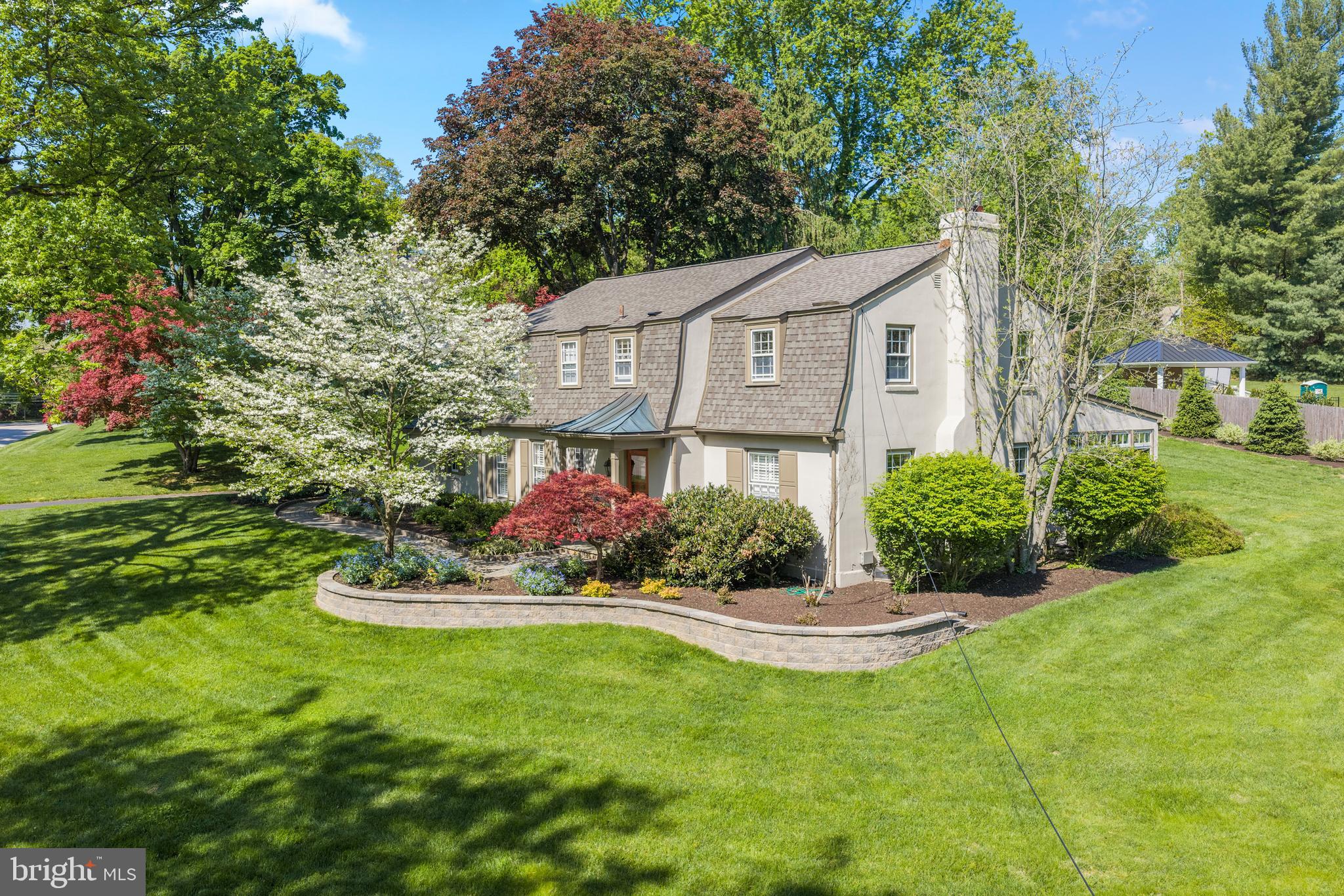 Welcome to 977 Ivycroft Road—where privacy, convenience, and timeless style come together in a beautifully updated two-story Colonial. This home blends classic charm with modern upgrades, offering a warm and inviting layout designed for both everyday living and entertaining.
Step into a gracious center hall that opens to a main level with seamless circular flow. The spacious living room and formal dining room provide elegant gathering spaces, while the chef’s kitchen serves as the true heart of the home. Thoughtfully designed, it features a Viking Professional range, Sub-Zero refrigerator, Bosch dishwasher, custom cabinetry, a large island, and exceptional storage solutions.
The kitchen flows effortlessly into the family room, ensuring you’re always part of the action. A stunning breakfast area with vaulted ceilings, skylight, and a wall of windows fills the space with natural light by day and offers peaceful nighttime views. Just beyond, an extraordinary sunroom provides the perfect spot to enjoy your morning coffee. The home’s layout creates a wonderful indoor-outdoor connection, ideal for both large-scale entertaining and relaxed daily living. Hardwood floors extend throughout the main and second levels. 
Upstairs, you’ll find a spacious primary suite along with three additional bedrooms. The primary retreat features two walk-in closets with custom organization systems and a beautifully updated bath with an oversized shower. There is plenty of closet space and a spacious updated hall bath. A large walk-up attic provides abundant additional storage.
The lower level is designed for entertaining, complete with a custom kitchenette, refrigerator, island, and built-in cabinetry- making it perfect for hosting guests or creating a comfortable recreational space.
Back to the main level, at the rear of the home, the attached garage, main-floor laundry, and spacious mudroom with custom built-ins enhance everyday convenience, organization, and ease of access.
Outside, a large flagstone patio serves as a natural extension of the home, easily accessible from the kitchen, breakfast area, and sunroom. The thoughtfully designed gardens and hardscaping reflect careful planning and pride of ownership, creating a beautiful and functional outdoor retreat. 
Enjoy peace of mind with a brand-new roof and energy-efficient natural gas HVAC system, both installed in Fall 2025. 
Perfectly situated on a quiet street just moments from downtown Wayne, transportation, exceptional dining and shopping, and major highways…977 Ivycroft Road is truly an unbeatable Main Line location.