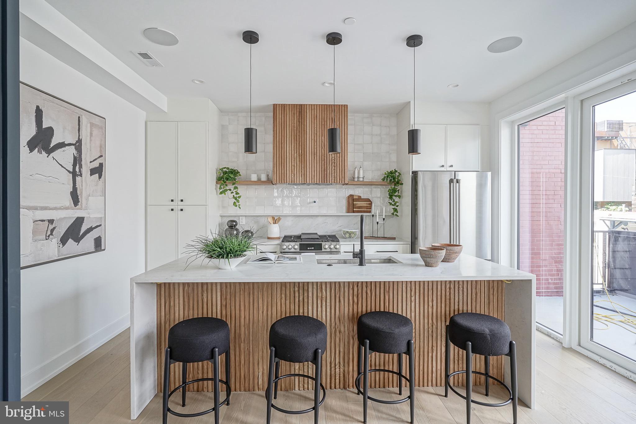 ** Only 3 units remain (1 corner unit / 2 interior units) ** Ask for the link to the VIDEO TOUR and information on plans & finishes. ** For a limited time, buyers have the ABILITY TO CUSTOMIZE ** Unit 4 is PENDING prior to completion - Asking Price $1.5M ** Nestled in the renowned Alexander Adaire Catchment. Introducing one of Philadelphia's most distinguished, private townhome residences. A rare opportunity crafted by the region's elite developers, designed for those who appreciate timeless elegance, superior craftsmanship and an upcompromising lifestyle. Enticing 10 YEAR TAX ABATEMENT included with each property. Featuring incredibly rare 3 CAR GARAGE, including a private drive isle, in the city. Savor the wealth of restaurants, bars, cafes, lounges, shops, gyms and the entertainment of Frankford Avenue. Take a quick walk over to the waterfront for parks and entertainment. Quick walk to enjoy even more restaurants and entertainment in Northern Liberties and Old Kensington. For transportation: In close proximity to Highway 95, Ben Franklin Bridge, Betsy Ross Bridge, Philadelphia International Airport and the Market-Frankford Blue Line (to Old City, Center City, 30th Street Station, University City, West Philly and Northeast Philly). Arrive at the ground level where a grand three-car garage sets the tone for sophistication and space. A private foyer, complete with ample closet space, offers a warm and functional welcome. Just beyond, a versatile open area awaits—ideal for a spacious home office, personal gym, or guest retreat—with a stylish en-suite bathroom for added comfort. Ascend to the second level and be captivated by an expansive open-concept layout that seamlessly integrates the grand living and dining areas with a truly showstopping kitchen. Towering 7-foot windows flood the space with natural light, creating an inviting atmosphere throughout. The living room is anchored by an elegant fireplace, media center, dry bar, and a refined powder room. The dining area is adorned with its own dry bar and a custom wine wall, perfect for effortless entertaining. The gourmet kitchen is a masterpiece of design and function, featuring premium GE Cafe appliances, a striking waterfall island with breakfast bar, exquisite quartz countertops, and the opportunity to personalize finishes to suit your taste. A dramatic 4-panel glass folding door, measuring 8 feet by 10 feet, connects your kitchen to a private balcony, blending indoor and outdoor living in spectacular fashion. On the third level, a serene guest suite offers privacy with its own en-suite bathroom.  This floor also includes a spacious hallway bathroom, a full laundry room, and two generously sized guest bedrooms. Each bedroom is adorned with oversized 5- and 7-foot windows to welcome in radiant natural light. The private primary suite commands the top floor. Your opulent sanctuary featuring a generous bedroom with a cozy fireplace and built-in media center. Multiple closets, including a luxurious walk-in, provide abundant storage. The spa-inspired bathroom is a true retreat, boasting a private water closet, a grand 96-inch dual vanity, an oversized glass-enclosed shower with bench seating, and a freestanding deep soaking tub. Just outside your suite, double doors lead to a refined home office, while a private powder room accommodates rooftop guests. The stairwell ascends to an expansive roof deck. An entertainer’s dream with ample space and customizable options for an outdoor kitchen, dining, and lounge. Buyers are responsible for verifying taxes and square footage.