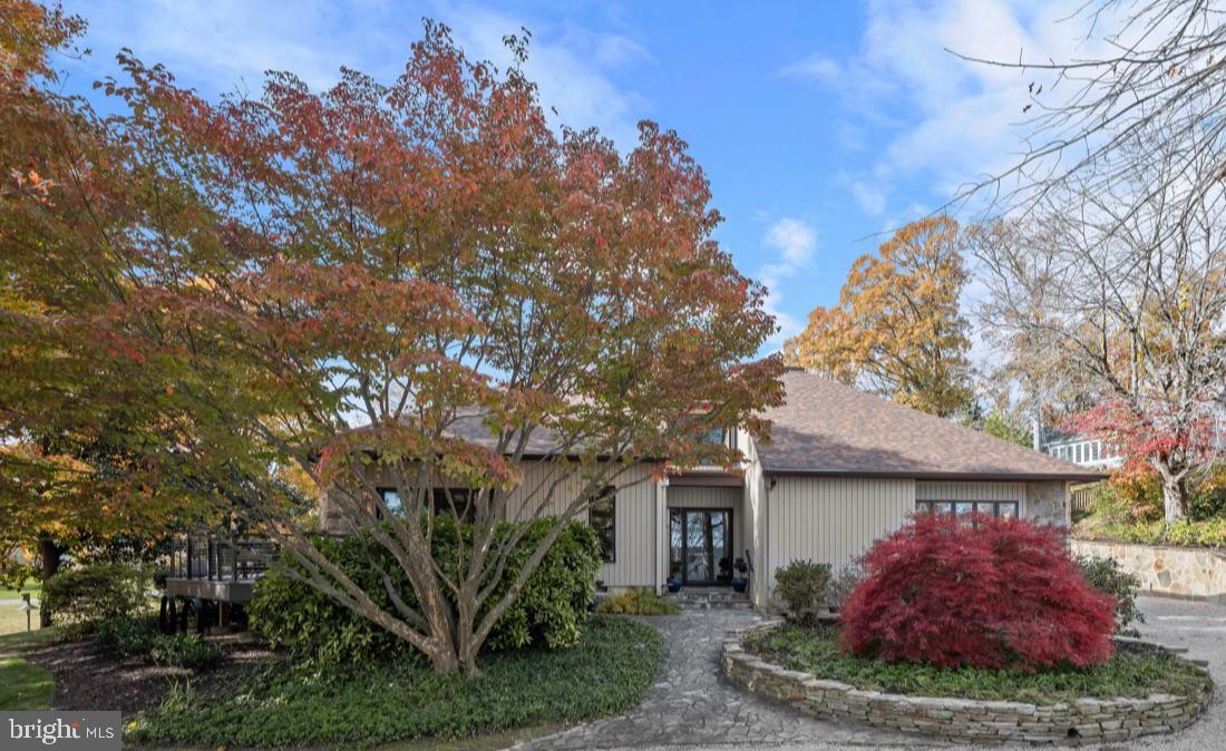 Beautifully updated, move-in ready, and just in time for summer!
Nestled on nearly half an acre of beautifully landscaped grounds, this elegant, fully renovated, contemporary home offers comfort, style, and privacy. Built in 1988 by premiere contractor Bert Winchester, and then beautifully remodeled by Think Make Build in 2021, this 3,809-square-foot exquisite residence has four bedrooms, and three and a half baths. A stone walkway and garden walls lead to an inviting front entrance. Surrounded by lush greenery, the property blends seamlessly with its natural setting and borders an undeveloped Gibson Island Corporation owned lot that ensures lasting privacy. Thoughtfully designed outdoor spaces encourage relaxation and connection with nature—ideal for morning coffee on the wrap around deck or evening gatherings in the secluded back courtyard. The courtyard is enclosed by beautifully crafted stacked stone retaining walls offering a rich, layered look with stone steps to the backyard.
The main level features a spectacular two-story great room with gorgeous finish work, including built-ins, a handsome stone gas fireplace and multiple open living and dining spaces. Enjoy the inviting cozy den overlooking the backyard with a second stone, gas, fireplace, a newly renovated chef’s dream gourmet kitchen, complete with high-end appliances and custom teak style cabinetry, and wet bar, plus an additional built-in outdoor kitchen with Wolf appliances.  The main level offers a primary bedroom suite with spa-like bath and a second bedroom with Murphy bed, which could also be used as a home office, with an ensuite full bath.  A beautifully designed laundry room with stunning cabinetry is located off the Kitchen.   Ascend the beautifully designed, modern open back tread stairs with cable railing to the upper level overlooking the gorgeous great room.  On the second level are two additional spacious bedrooms, a full hall bath, and an open sitting area. The lower level offers plentiful storage. There is a detached one car garage.
668 Broadwater Way is ideal for year-round living or a second home escape. The property combines the tranquility of nature with the sophistication of modern design. The home’s recent renovations and careful maintenance ensure a turnkey experience for its next owner. This is a rare opportunity to own a distinguished property that perfectly captures the charm of Gibson Island living.

Information on Gibson Island:
Gibson Island is a private island within one hour of Washington, D.C. and Baltimore offering an absolutely extraordinary setting.  The Island comprises 1000 acres with seven miles of shoreline. Two thirds of the Island is undeveloped and is owned by the Gibson Island Corporation, the homeowners' association.  The remaining third is residential home sites. 
Gibson Island is located on the western shore of Maryland, so there is no need to cross the Bay Bridge. On the Island is a 43-acre spring fed freshwater lake in which one may enjoy non-motorized watercraft activities such as paddleboarding, canoeing, kayaking, fishing and swimming.  
The Island offers enormous privacy and security--there is an entry gatehouse staffed 24+Hours, and the Island is patrolled by the Gibson Island Police Force (GIPD).  The Gibson Island Corporation Service Department offers yard maintenance and landscaping and other services for homeowners.  There is a full-service yacht yard.   From the Island, it is just a 20-minute drive to BWI Airport and the neighboring Amtrak train station.  
The Island houses a private country club (membership by invitation) offering yachting, fine dining year-round, tennis, an award-winning Charles Blair Macdonald designed 9-hole golf course, swimming, croquet, skeet shooting, and more.  (C)
