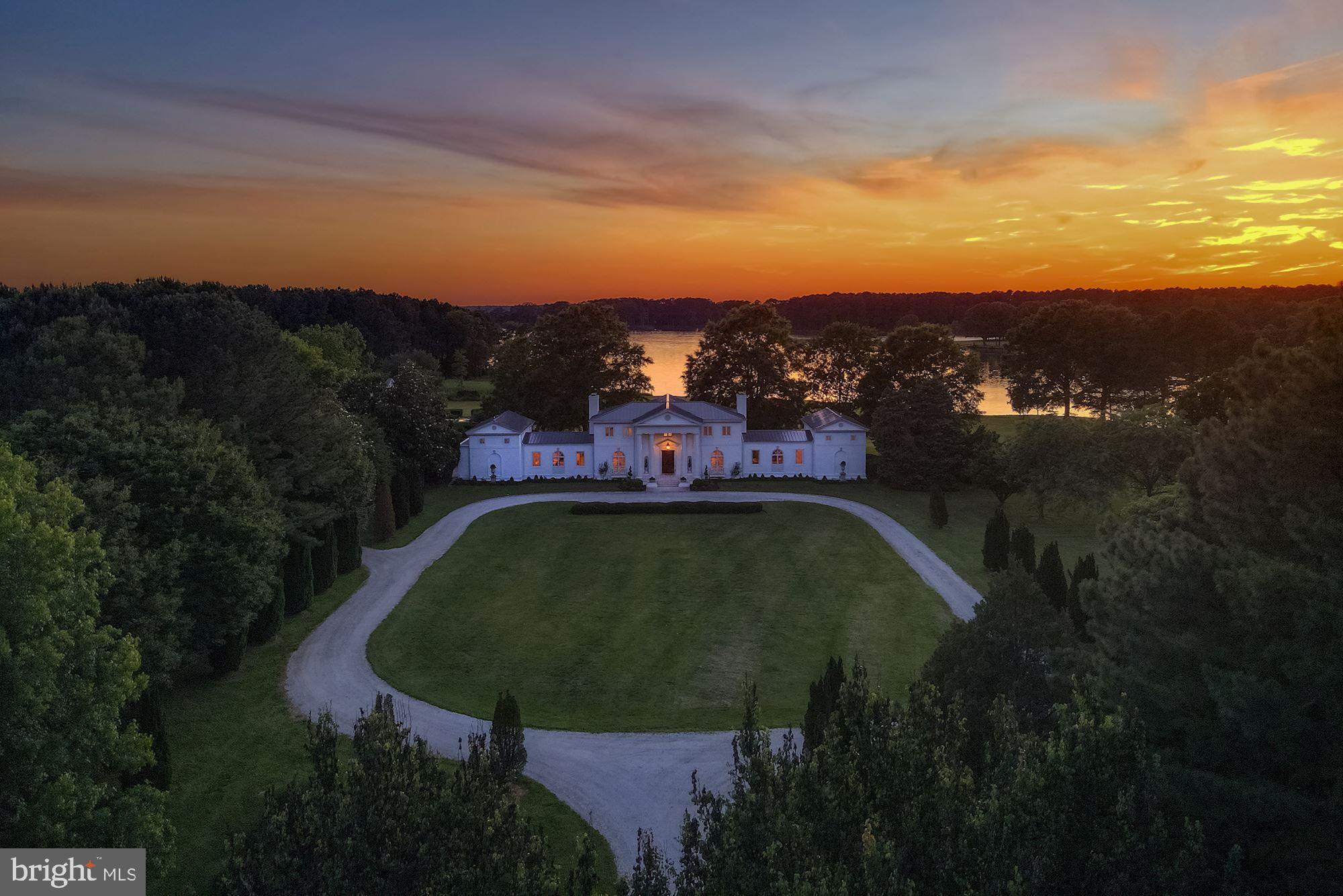 Belle Rive, an enchanting 130+ acre waterfront estate with over 1400’ of direct water frontage on Leeds Creek,  home to many magnificent manors and estates of Maryland’s storied Eastern Shore. This custom-designed residence is highlighted by grand rooms, a private beachfront, a multi-slip pier, a 2.5 acre pond, and a two-story pool house with a guest suite, outdoor kitchen, patio, and elegant swimming pool. The main residence welcomes you via a 2-story open center hall foyer with a custom mural, grand circular staircase. To the left of the foyer is the grand dining room with a fireplace and seating for up to twenty guests. The adjoining, classically-designed gourmet chef’s kitchen features a fireplace that is an exact replica of a French hearth. Special amenities include a La Cornue range, expansive marble-topped island, breakfast area, pantry, and top-of-the-line appliances. Beyond the kitchen is the oversized family room that opens to beautifully landscaped side patio. Continue from the family room up a staircase to a bright library (or home office/ guest suite, or 6th bedroom) with a terrace and full bath. To the right of the foyer are the grand double living rooms, each with their own fireplaces. French doors from all public room open to the rear patio overlooking the sweeping yard and expansive water views, perfect for entertaining. Beyond the living rooms, a private hallway leads to two main level guest bedrooms and full bath. Designed to be a wing of their own, these bedrooms offer complete privacy for houseguests and easy access to the grounds and other amenities. The upper level of the home features a spacious, sun-filled primary suite with water views, a fireplace, a completely updated luxurious marble bath, and a large master closet. Two additional bedrooms each with ensuite baths, and a laundry room complete the second level.  Views from every part of this stunning residence are absolutely breathtaking. Outside, enjoy the verdant grounds with manicured lawns and mature landscaping. A pathway leads to the exquisite pool house and inviting pool. The 2-story pool house boasts an outdoor kitchen, large indoor bar, sitting room, billiard room with fireplace, 2 bedrooms, 2 full baths, laundry, and open porch with fireplace make for a perfect environment for entertaining.  Additional amenities on this mesmerizing property include the 2.5 acre fully stocked pond with a duck blind, brand new 4-car garage with mahogany doors, farmland, wooded acres, private beach, and such much more.  Truly a must see!