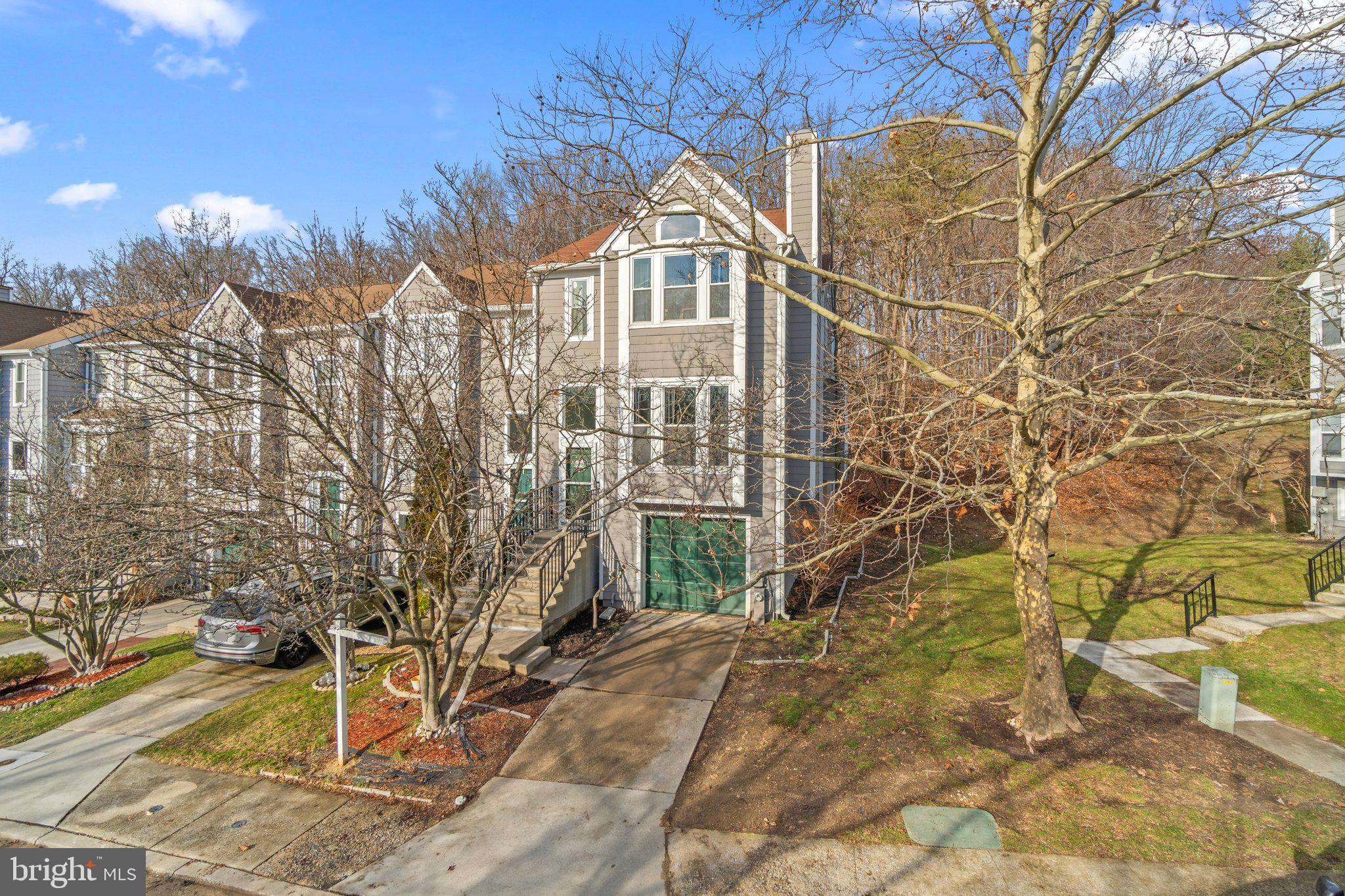 ****OPEN HOUSE FOR 2/3 CANCELED.**** Welcome to one of the largest end units in Woodland Village with over 2,500 square feet. The several bump-outs of this rare home not only give you extra space but also features oversized windows that bring in a ton of natural light. The main level has real hardwood floors, a step-down living room with built-in bookshelves, a fireplace, a powder room, dining room with double doors leading to the kitchen, and a breakfast room with floor-to-ceiling windows on each side of the sliding door overlooking the private wooded lot and the oversized deck! You will fall in love with the huge master ensuite with vaulted ceilings, extra space for a home office or sitting room, and an updated master bath. Ready to make it your private oasis. The upper level also has two additional bedrooms and another full bath. On the lower level you will find the door leading to the garage, a lot of storage space, another half bath, and a large family room. This beautiful home has so much space and is move-in ready! Roof and hvac replaced in 2018, water heater 2024. Master bath remodel 2024.