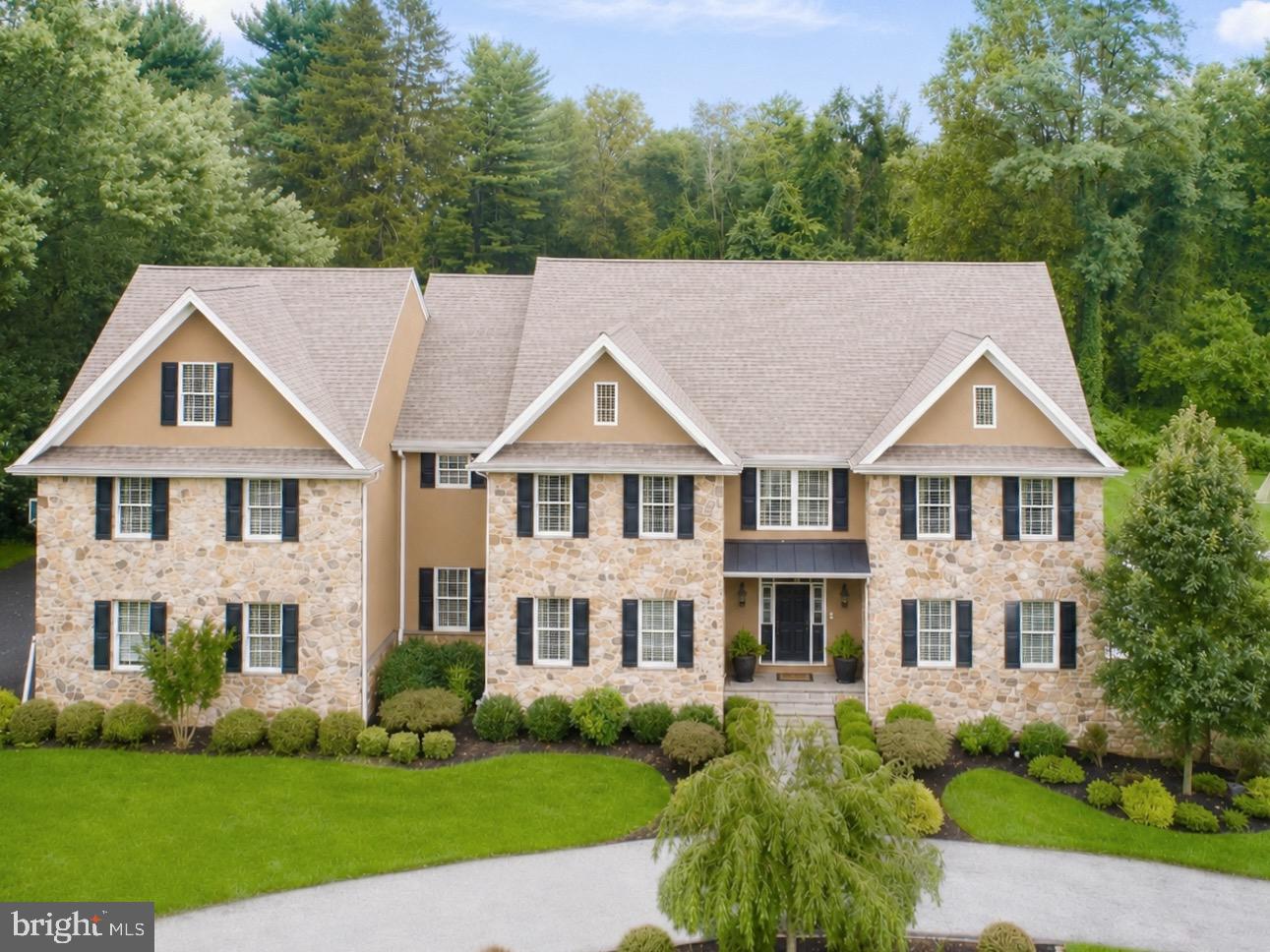 Welcome to 408 Mattrissa Ridge, an exceptional luxury estate nestled in the prestigious community of Darlington Pointe and within the award-winning Rose Tree Media School District. Meticulously curated and beautifully maintained, this remarkable residence offers an unparalleled blend of timeless elegance, sophisticated design, and resort-inspired living. A grand and inviting floor plan unfolds with gleaming hardwood flooring, extensive custom millwork, and professionally curated spaces ideal for both intimate gatherings and large-scale entertaining. At the heart of the home, the gourmet chef’s kitchen is a masterpiece, featuring commercial-grade appliances, floor-to-ceiling custom cabinetry, a butler’s pantry, and an adjoining breakfast room overlooking the grounds. The kitchen flows seamlessly into the stunning family room, where a coffered ceiling and dramatic floor-to-ceiling stone fireplace create a warm yet refined atmosphere. A formal dining space provides the perfect backdrop for elegant entertaining, while a private first-floor guest suite with ensuite bath, walk-in closet, and custom built-ins offers exceptional flexibility for extended family, guests, or an au pair. A richly appointed office with custom built-ins, mudroom with custom cubbies, laundry room, and stunning powder room complete the main level. The upper level is anchored by a luxurious owner’s retreat featuring an expansive custom walk-in closet and a spa-inspired bath with dual vanities, soaking tub, dedicated vanity area, and oversized shower. Four additional spacious bedrooms and three beautifully updated bathrooms provide comfort and privacy for family and guests alike. The fully finished lower level rivals the finest private clubs, offering a dedicated fitness area with sauna, theater space, custom bar, and full bath—creating an extraordinary destination for recreation, wellness, and entertaining. Beyond the interior, an extraordinary backyard oasis awaits. Designed for effortless indoor-outdoor living, the grounds showcase an expansive travertine terrace, a spectacular zero-entry pool with cascading spa, outdoor kitchen and grilling station, stacked stone fireplace, and an impressive pool house complete with its own kitchen and bath. Whether hosting a summer gathering or enjoying a quiet evening at home, the outdoor spaces offer a true resort-style experience. Expansive lawn areas provide abundant space for recreation, gardening, and play while maintaining a sense of privacy and tranquility. Ideally located just moments from the charm of Media Borough’s acclaimed restaurants, boutiques, farmers markets, community events, and popular Dining Under the Stars, 408 Mattrissa Ridge presents a rare opportunity to enjoy luxury living at its finest in one of Delaware County’s most sought-after locations.