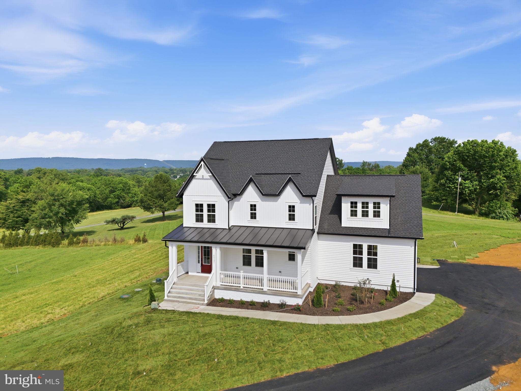 **New construction home for immediate move-in. Photos in the listing are photos of the actual house.** Welcome to 40321 Quarter Branch Road, a thoughtfully designed new construction home in Lovettsville offering 3,040 finished square feet above grade, a functional floor plan, and modern farmhouse-inspired curb appeal. Situated on a spacious 1.56-acre homesite, this 4-bedroom, 4-bath residence blends open-concept living with flexible spaces designed for today’s lifestyle.

The main level features LVP flooring, oak stairs, full bathroom, a spacious family room with propane fireplace, and an open kitchen anchored by a large island, propane cooktop, wall ovens, walk-in pantry, and generous dining area. A main-level bedroom offers flexibility for guests, a home office, or multigenerational living.

Upstairs, the primary suite includes a large walk-in closet and well-appointed bath, while two secondary bedrooms share a Jack-and-Jill bathroom. A finished bonus room with attached full bath provides ideal space for a guest suite, playroom, media room, or additional office.

Additional highlights include upper-level laundry, screened deck, covered front and rear porches, unfinished walkout basement with bathroom rough-in for future expansion, 537-square-foot attached 2-car garage, asphalt driveway, private well and septic, and no HOA.

Located in western Loudoun County, this newly built home offers the opportunity to enjoy modern construction, functional design, and the charm of Lovettsville’s countryside setting while still maintaining access to modern connectivity, including high-speed wireless internet availability. Offered with a 2-10 Home Buyers Warranty for additional peace of mind.