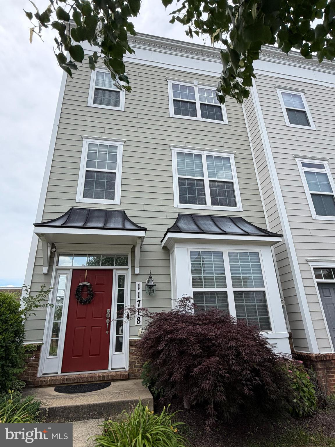 End-unit townhouse in the highly sought-after Leesborough community! This exceptional floor plan offers three finished levels of stylish and comfortable living space. Large windows throughout fill every level with abundant natural light, while recessed lighting in every room enhances the home's bright, modern feel. This spacious home features 4 bedrooms and 4 full bathrooms, including 2 en-suite bedrooms that provide privacy and flexibility for family members or guests. The entry level includes a bedroom with its own en-suite full bath, making it ideal for guests, in-laws, or a home office. The main level features a spacious living room, a gourmet kitchen, an adjacent dining room, and a full bath for the convenience of guests. Upstairs, the spacious primary suite offers a walk-in closet, double-sink vanity, and a large walk-in shower. Two additional bedrooms share a full hallway bath. The conveniently located upper-level laundry room includes a washer and dryer that were replaced in 2021. The gourmet kitchen is designed with granite countertops, stainless steel appliances, under-cabinet lighting, and ample cabinetry, making it both functional and inviting for everyday living and entertaining. Additional highlights include a rear-loading two-car garage. Conveniently located just three-quarters of a mile from Wheaton Metro, this home is also within easy reach of the Wheaton Library and Recreation Center, Safeway, Westfield Wheaton Mall, shopping, restaurants, and numerous everyday conveniences. Residents of the Leesborough community enjoy guest parking, street parking, a tot lot, picnic area, and doggy stations. This beautifully maintained home offers the perfect combination of location, space, and convenience.  It is a wonderful place to call home!