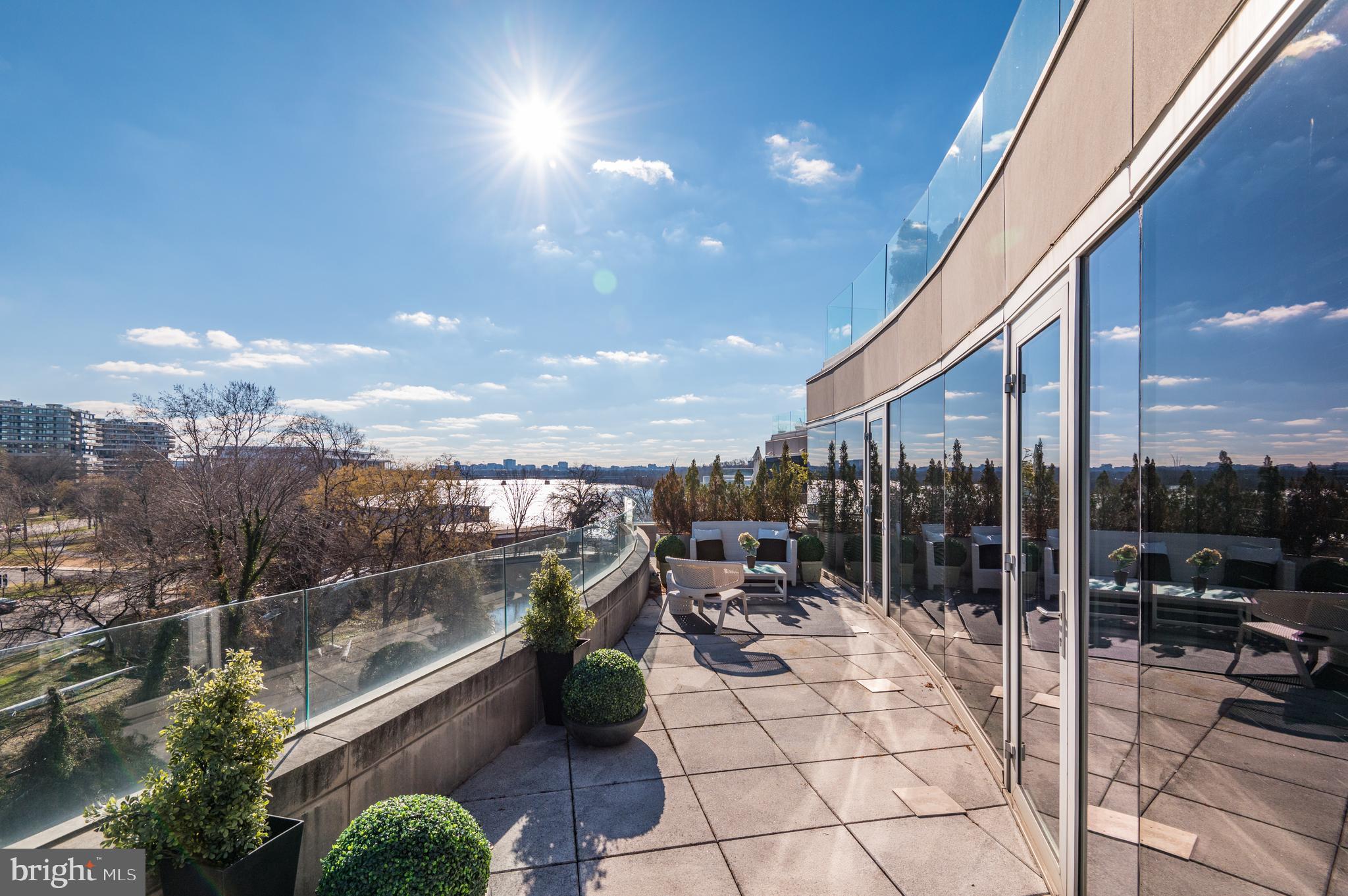 Fabulous New Price! Welcome to 2900 K Street NW at HARBOURSIDE, a special enclave of 7 penthouse residences located in Georgetown adjacent to the Swedish Embassy and Potomac Riverfront.    Unit 607 was one of the developers own homes, filled with upgrades that make elegant entertaining and everyday living extra special.   A double door entry welcomes you into a marble foyer with extra high ceilings, an inviting semi-circular glass entertaining bar, custom cabinetry and gas fireplace.  The foyer leads to a spacious marble floored living room and dining room, which both open onto the main level balcony which spans the entire side of the residence and provides breathtaking views of the city.   The primary suite is designed on one side of the apartment just past the living room and dining room with a huge designer primary bath and multiple closets with custom built-ins.  The primary suite has floor to ceiling windows and opens as do most rooms to the extra wide outdoor balcony.

The opposite side of the residence includes a large family room with fireplace open to the gourmet kitchen with island, plus two additional guest bedrooms with ensuite baths.   A fourth den with full bath is also found in this wing of the apartment along with a full size laundry and a powder room that wraps around through the hallway to the front foyer.
An artfully designed staircase leads off the front foyer upstairs to the second level of the home.  Here you will find a huge home office with space for staff, plus built ins and skylights, a second family room and gym with fireplace, and a fifth room with ensuite bath that serves as the fourth bedroom and bath.  The second level of the apartment opens to a full size balcony with glass railings and panoramic views of the city and the Potomac River.   Three car garage parking, a full-time concierge, security desk and private elevator entry to the 6th floor residences all combine to make Harbourside a very private luxury condominium option with extraordinary views of Georgetown, the Kennedy Center, Watergate and Potomac River.  A total of four bedrooms, five full baths, den/guest bedroom, full size office and two wrap around balconies with extraordinary outdoor entertaining space and spectacular views.    Fifteen minutes to National Airport, twenty five minutes to Dulles International Airport.   Five minutes from the Kennedy Center, and ten minutes to the White House.