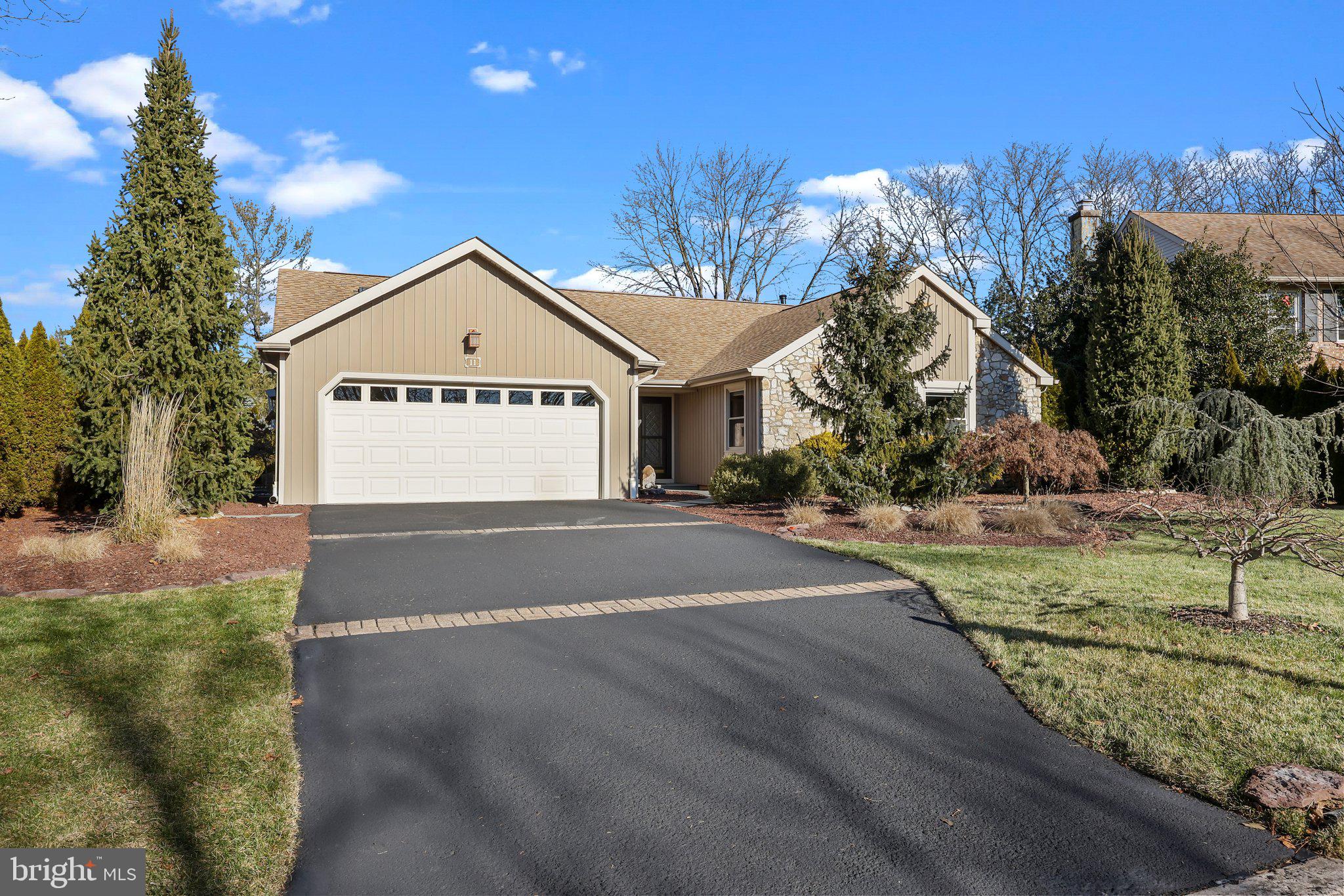 Welcome home to 11 Jasmine Court, first-floor living at its finest on a peaceful cul-de-sac in the heart of bucolic Bucks County. Every square inch of this property has been freshly painted and redefined with both form and function in mind - including newer siding, windows, skylights, and doors. Walk through the front courtyard with custom landscaping and bluestone slate walkway at the inviting covered entry. Gather around the gas fireplace with custom marble surround and inlaid Moravian tile details around the hearth in the great room with natural light pouring through skylights in the vaulted ceiling. Thick crown molding and baseboard continue into the sunny dining area. The bright chef's kitchenoffers updated cabinetry, stainless steel GE appliances, built-in refrigerated wine storage, gas range, center island, instant hot water heater, and skylight with remote control shade. The newly renovated four-season sunroom features a serene sitting area for morning coffee or evening cocktails as the sun sets. Enter the primary bedroom suite through French doors to find a generously-sized bedroom, walk-in closet, and tastefully remodeled bathroom with custom tiled walk-in shower and separate vanities with raised counter height. Two additional bedrooms with large closets and spectacularly wide wooden window sills share a remodeled hallway bathroom. The partially finished daylight basement offers two separate living spaces with custom-lit coffered ceilings. The bone-dry unfinished spaces store the newer HVAC system (2022) with Aprilaire humidifier, new sump pump (2023), new water heater (2023) central vacuum system, French drain, and a fabulous walk-in cedar closet. The newer whole-house generator (2018) offers peace of mind in every season. Back on the main floor, convenient first-floor laundry is located in the mudroom between the kitchen and oversized two-car garage with abundant storage space, coated floor, and track organizer system. The highlight of this home is undoubtedly the beautiful backyard spaces, with sprawling paver patio, grassy lawn, low maintenance perennial garden, and specimen trees, including deep pink redbud trees and white Kousa dogwood blossoms bursting in the spring. The cul-de-sac is within reach of the walking path, connected to the Newtown Trail System. Located in close proximity to Tyler State Park and all that Newtown Borough has to offer, and assigned to award-winning Council Rock North High School - Don’t miss this incredible opportunity!
