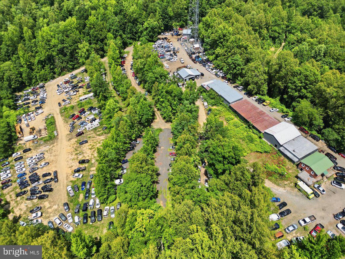 Rare Opportunity to Acquire a Fully Operational Auto-Related Business on 19.35 Acres. The sale includes approximately 19.35 acres of land, all existing improvements, buildings, equipment, and the operating business currently conducted on the property.  This established and fully equipped operation includes multiple revenue-generating business components and licenses, including: Auto Salvage Yard, Vehicle Removal Operator, Scrap Metal Processor, Oil Storage Facility,  Tire Storage Facility, Used Auto & Truck Dealership, Auto Auction Platform, Auto Recycling Operations, Auto Rebuilder, Auto Demolisher, Truck & Automotive Maintenance Facility.  The property is improved with multiple warehouse and flex-use buildings totaling approximately 12,390 square feet, including a service facility featuring eight overhead doors. Prime Location - Strategically located near:  Interstate 95 (I-95), Route 1, Route 3, U.S. Route 301 and the Governor Harry W. Nice Memorial Bridge to Maryland, This location provides convenient access to major markets including: Washington, D.C., Richmond, Virginia, Baltimore, Maryland, Fredericksburg, Virginia. The property offers a unique combination of industrial land, established operations, valuable business licenses, and excellent transportation access, making it ideal for investors, owner-operators, recyclers, salvage businesses, automotive companies, and related industrial users.  This is a rare opportunity to acquire a long-established, fully operational business with significant infrastructure and expansion potential.