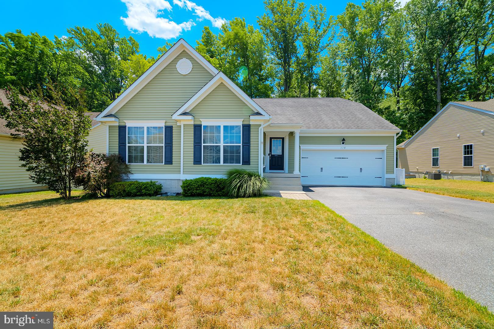 Charming coastal home located in the desirable Setterfield community of Felton, Delaware, offering the perfect blend of comfort, style, and convenience. Built by the respected Garrison Homes, it features a new A/C system and has been freshly painted with premium Benjamin Moore paint. The HOA fee is just $250, adding to the home's overall value and appeal. This beautifully designed home features 3 bedrooms, 2 bathrooms, and an inviting open-concept floor plan enhanced by Pergo HD laminate flooring throughout the main living areas. The gourmet kitchen is the heart of the home, showcasing a large two-tier granite island with counter seating, 42-inch cabinetry, stainless steel appliances including a gas range, built-in microwave, and refrigerator, plus a spacious pantry for ample storage. The kitchen flows seamlessly into the dining area, highlighted by a specialty light fixture and easy access to the expansive rear deck, making indoor-outdoor entertaining effortless. The private main-level primary suite offers a relaxing retreat with a dramatic 10-foot tray ceiling, ceiling fan, full-length windows overlooking the wooded backyard, a walk-in closet, and a luxurious ensuite bath featuring dual vanities, a garden soaking tub/shower combination, natural light from a window, and a private water closet. A split-bedroom floor plan provides added privacy for family members or guests. The full unfinished basement offers endless possibilities with insulated walls, a concrete floor, egress window, and a three-piece bathroom rough-in, ready for future expansion. Outside, the large deck overlooks a peaceful wooded backyard, creating the perfect setting for gatherings or quiet evenings. The oversized two-car garage features a durable epoxy-coated floor and abundant storage space. Ideally located near Dover Air Force Base, Route 1, Downtown Dover, and Delaware's beautiful beaches, including Killens Pond State Park and the charming waterfront community of Bowers Beach, this exceptional home offers plenty of room to entertain while enjoying easy access to shopping, dining, recreation, and coastal attractions.