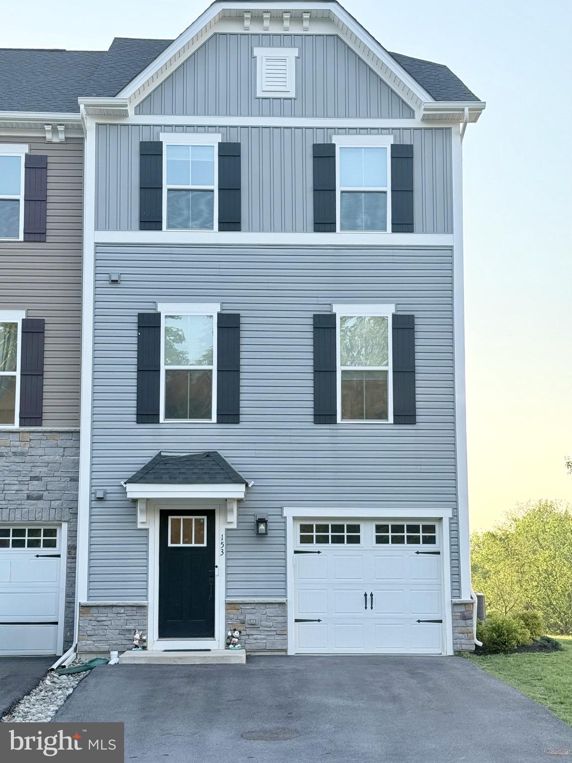 Built in 2023 and beautifully maintained, this move-in ready end-unit townhome in the sought-after Mapleview community offers modern comfort, low-maintenance living, and one of the best locations in the neighborhood. Backing to peaceful meadows and wooded open space, this home enjoys exceptional privacy and scenic views rarely found in townhome living. Located in the award-winning Downingtown Area School District, this spacious 3-bedroom, 2 full and 2 half bath home combines style, comfort, and community in a truly turnkey package.
Step inside the fully finished walkout lower level, offering flexible living space ideal for a family room, home office, gym, or playroom. Complete with a powder room, direct access to the attached garage, and sliding doors leading outside, this level seamlessly connects indoor and outdoor living. Beyond the backyard, enjoy acres of open meadows and walking trails that create a peaceful, park-like setting right outside your door.
The sun-filled main level features windows on three sides, flooding the spacious living and dining areas with natural light. Luxury engineered flooring and recessed lighting enhance the bright, open-concept layout designed for both entertaining and everyday living. A gourmet kitchen boasts a large center island, granite countertops, stainless steel appliances, gas range, double sink and abundant cabinetry. Sliding glass doors lead to a spacious, private deck overlooking the natural surroundings — the perfect place to enjoy morning coffee, outdoor dining, or relaxing evenings surrounded by nature. A conveniently located powder room completes this level. 
The upper floor offers a spacious primary suite with plush carpeting, tray ceiling, oversized walk-in closet, and a beautifully appointed en-suite bath with dual vanities and a walk-in shower. Two additional generously sized bedrooms, a full hall bath with tub/shower combination, and a convenient second-floor laundry area complete the upper level.
A preexisting inspection has been done and the complete report is available  to give confidence and security to the next owner. Why wait for new construction when this nearly new home is already beautifully finished and ready to enjoy? Mapleview offers beautifully maintained grounds and an unbeatable location just minutes from shopping, dining, parks, major commuter routes, SEPTA/Amtrak, Marsh Creek State Park, and Applecross Country Club. This exceptional home offers the perfect combination of modern luxury, privacy, and convenience in one of Downingtown’s most desirable communities. Be moved in before school starts!