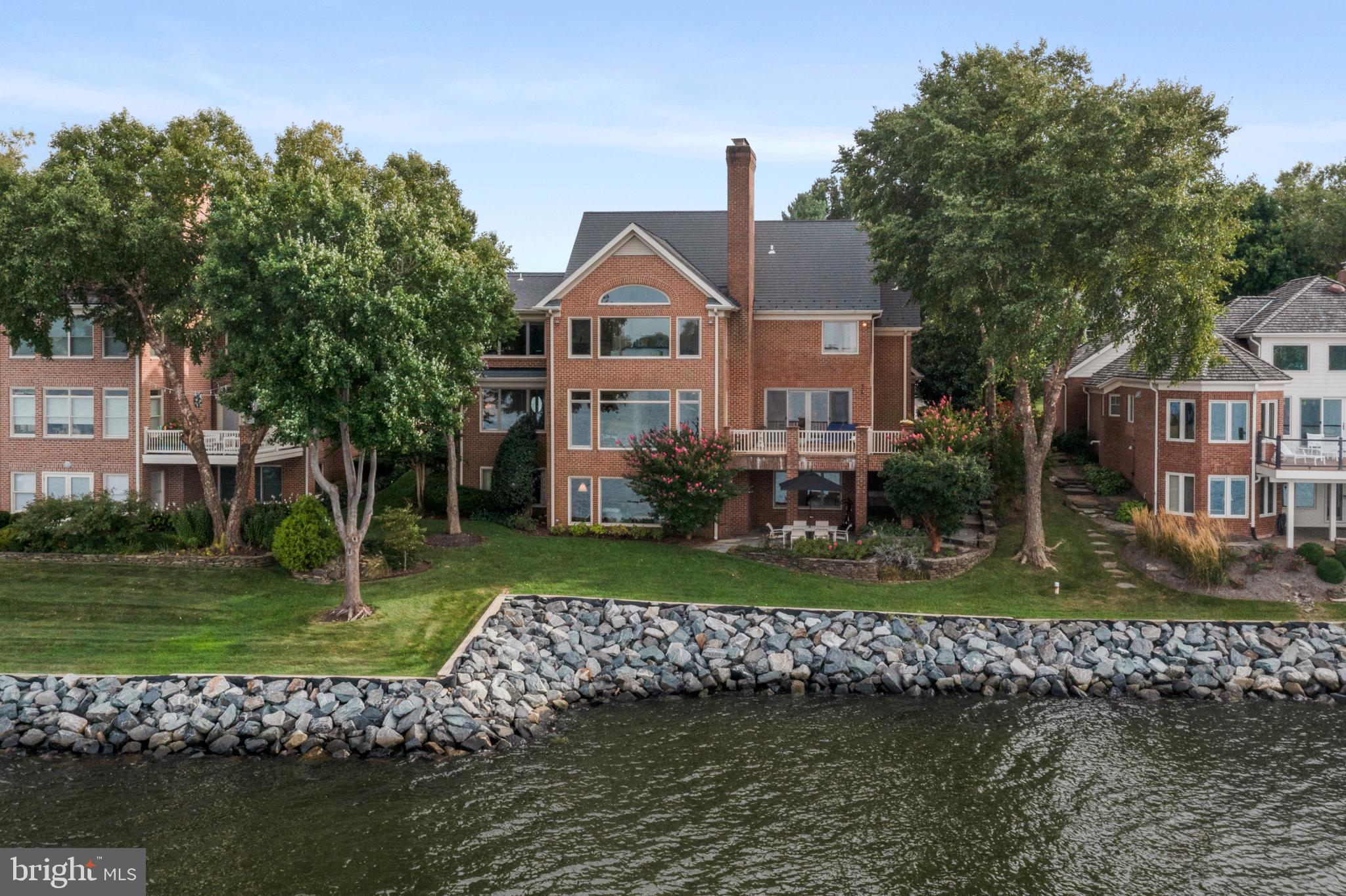 Stunning panoramic views across the South River from this finely crafted home! Immaculately kept and tastefully updated with style and true attention to detail.  Enjoy the wonderful open floor plan with outstanding flow for entertaining and everyday living. The crisp, clean design and custom features highlight the gorgeous views and give the illusion of being  on a luxurious yacht. The extra large waterside kitchen and breakfast room are the perfect place to cook a meal for 2 or 2 dozen and made for the way you want to live today. There is room for everyone to spread out and all rooms are welcoming and comfortable. The grand center hall with impressive water views and custom curved staircase leads to lovely rooms on all sides. The water views are maximized in the primary suite which is a true retreat designed for privacy and tranquility. The recently reimagined walk out lower level has two new designer baths, wide plank flooring, an over-the-top-fun and functional kitchenette, a great room with gas fireplace, two amazing bedrooms, a phenomenal covered waterside patio, separate laundry and great storage. Many, many updates and features include new windows, flooring, baths, kitchenette, HVAC, lighting fixtures, premium trim throughout, arched doorways, generator and new or newer appliances. Big garage with built-ins, work bench and pulldown storage. South River Landing is a true resort-style community with rich amenities including a deepwater marina, waterside pool, pool house, kayak and canoe racks, tennis, playground, a waterside nature trail, a private beach, 24/7 security gate with guard services and complete year-round homeowner and community landscaping services including mowing, edging, fertilizing, pruning, mulching, tree trimming  and snow removal. Close to Annapolis and a terrific location for commuters!