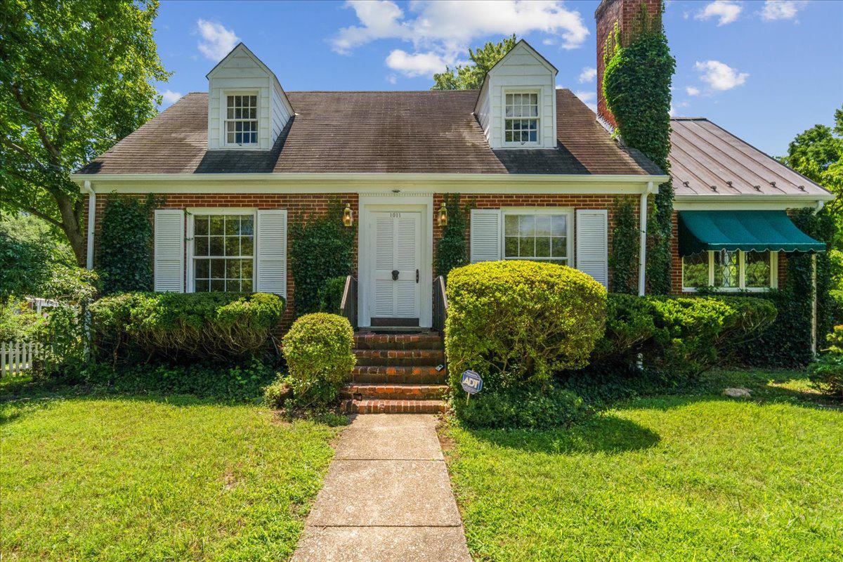 Nestled in the charming Burnt Mills Knolls neighborhood, this sweet Cape Cod offers a harmonious blend of classic elegance with custom touches throughout. Lovingly cared for by one owner!  This is an estate sale, being sold AS IS.  Needs some TLC, but great space on a lovely lot.  Step inside an inviting living room with natural light pouring in through an oversized front window, illuminating the rich hardwood floors and enhancing the cozy ambiance.  Gather around the wood-burning fireplace, for cozy evenings at home. The original brass lighting adds warmth and character.
The eat in kitchen is equipped with a vintage GE 36 inch range- truly a time capsule piece.  A custom stained glass framed window adds whimsy and a splash of color. Exit from the kitchen to the back patio for summer meals outside.  Venture downstairs to a large basement with large windows that light up the space.  A wall of builtins and shelves will organize books, games and more.  Plants will thrive in your sunny window boxes.  Also includes a full laundry room with rear exit to the patio, as well as utility and storage rooms.  Outside, the property boasts a level, partly wooded lot that provides a serene backdrop for outdoor activities. Enjoy summer barbecues on the patio with a built-in BBQ grill, or simply relax in the rear yard, surrounded by lush greenery and a well-maintained garden/lawn view. The asphalt driveway accommodates two vehicles, with additional on-street parking available. Located in the middle of the block, this home offers a peaceful retreat while remaining conveniently close to local amenities. Close to the FDA headquarters, White oak shopping center, Trader Joes, North West Branch Park, Burnt Mills Hills (a lovely adjacent neighbor to walk in), Rte 29 which heads into the Silver Spring Red line metro stop, 495 and numerous bus lines. A leafy urban/suburban neighborhood that provides a tranquil retreat while being close to everything. Don't miss it!