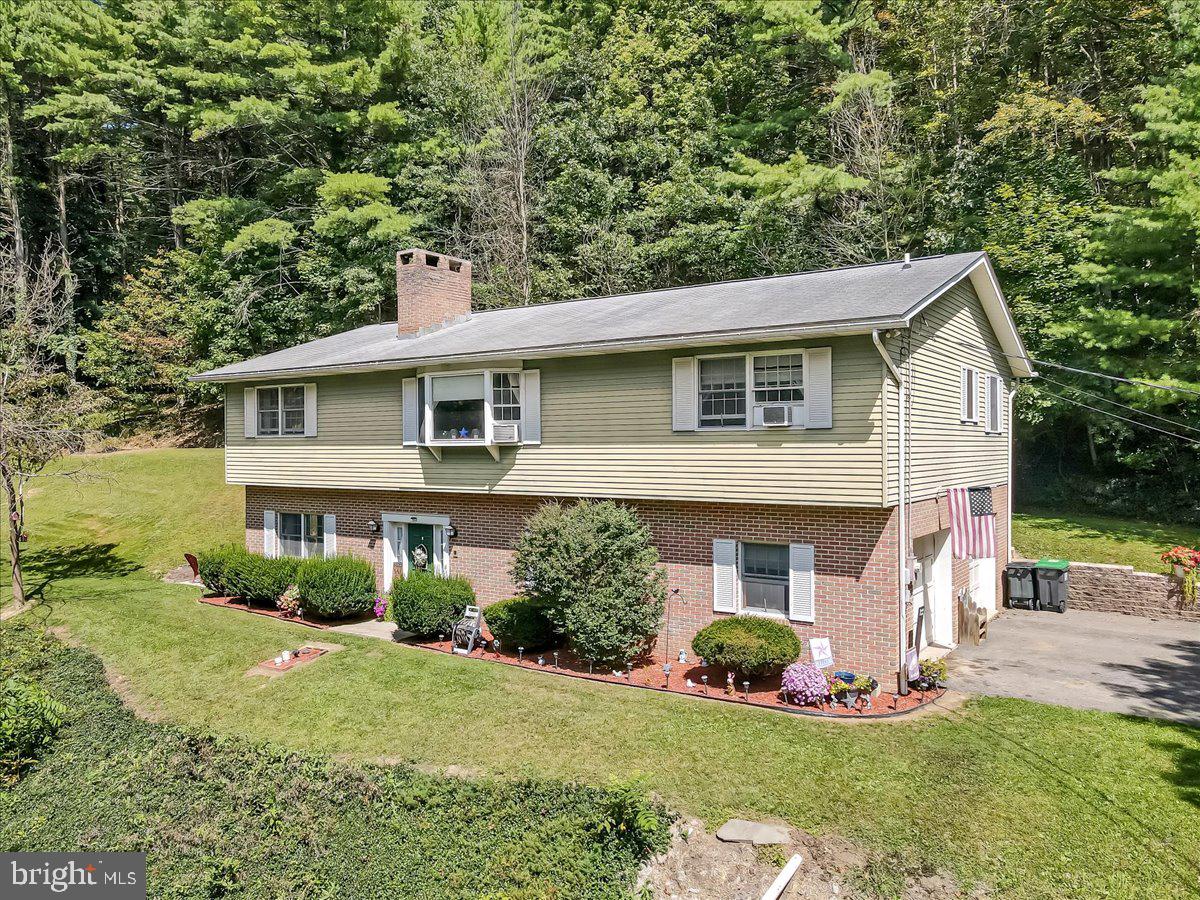 Be King of the Hill in the Mahoning Valley! Welcome to this 3-bedroom, 2.5-bath raised ranch set atop approximately 45.5 acres of partially wooded land and rolling farmland, offering breathtaking views and unmatched privacy. This property blends rustic charm with endless opportunities for outdoor enjoyment, whether you're looking to hunt, farm, ride ATVs, or simply enjoy the peace and quiet of country living. Step inside to find original hardwood floors throughout the main level and bedrooms, plus two wood-burning fireplaces—one in the inviting living room and another in the spacious lower-level rec room. The kitchen and pantry area provide abundant built-in cabinetry for storage, perfect for both everyday living and entertaining. An oversized built-in 2-car garage offers plenty of room for vehicles, tools, or a workshop. Recent improvements include a brand-new roof installed in June 2026, providing peace of mind and added value for years to come. Outside, the acreage gives you the freedom to create your own private retreat—whether that means cultivating crops, setting up trails, establishing a hunting haven, or simply enjoying the natural beauty that surrounds you. The combination of open fields and wooded areas creates the perfect backdrop for recreation, wildlife watching, and country living at its finest. Located just minutes from Mauch Chunk Lake, local wineries, and a short drive to restaurants, shopping, and everyday conveniences, this property offers the best of both worlds—secluded country living with easy access to modern amenities. Don't miss this rare opportunity to own a true slice of the Mahoning Valley. With 45.5 acres, stunning views, a brand-new roof, and endless possibilities, your private escape awaits!