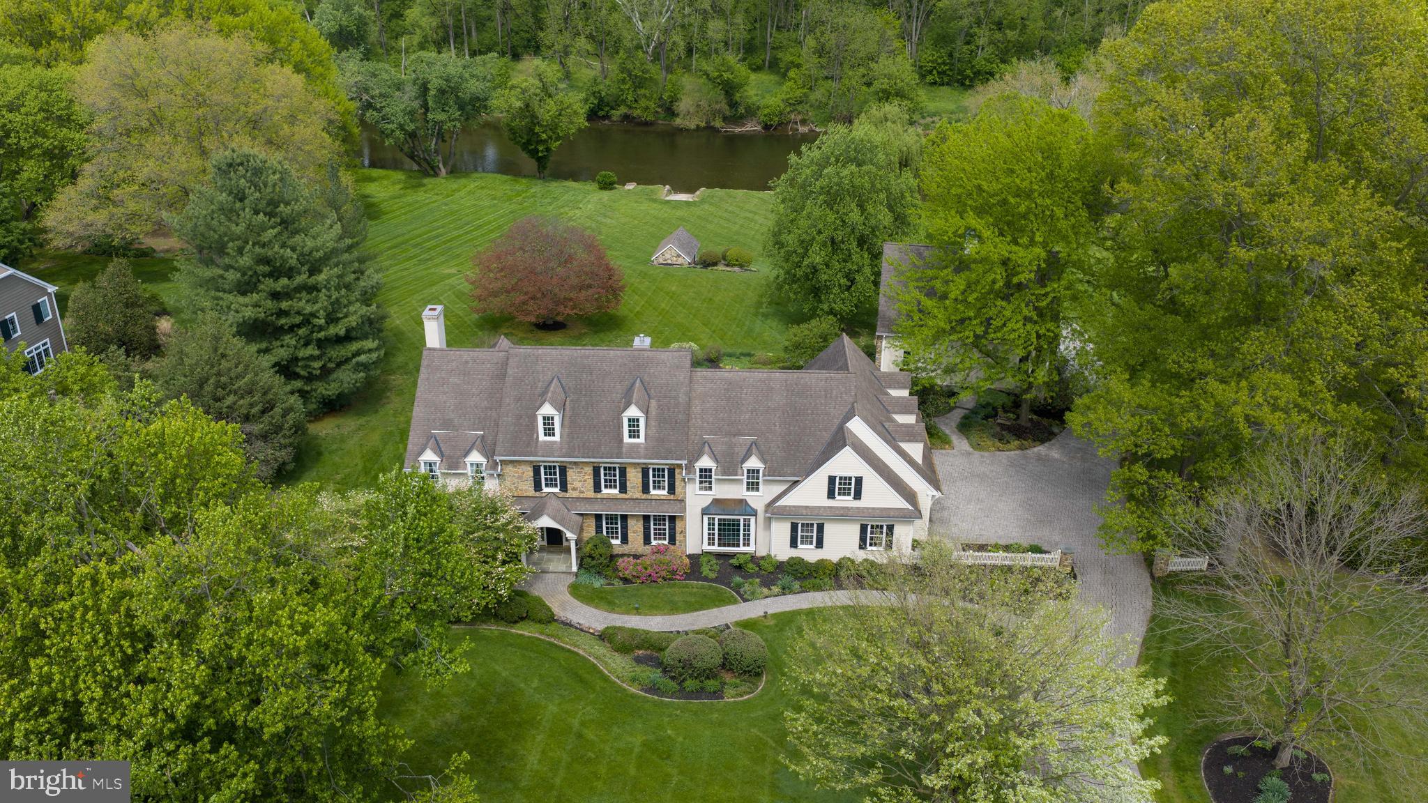 Welcome to 94 Leaman Road—an extraordinary waterfront estate set on 2.4 private acres along the Conestoga River, offering a rare combination of luxury living, functional versatility, and breathtaking natural surroundings. With direct river frontage and a private boat ramp for easy access, this property delivers a truly unique lifestyle defined by space, privacy, and connection to the outdoors.

The property features a stunning main residence, a fully finished recreation barn, and a separate spring house, all constructed with a timeless blend of stone, cement siding, stucco, and wood siding for enduring quality and architectural appeal.

The main house is a spacious 2-story home, featuring a refined layout showcasing hardwood flooring, detailed millwork, and expansive living areas throughout. The main level includes a formal dining room, a private office, and a dramatic great room with vaulted, beamed ceilings and a brick gas/wood fireplace, built-ins throughout, and an oversized 3-car garage with with additional laundry and workshop areas. The gourmet kitchen is thoughtfully designed with high-end appliances including a Sub-Zero refrigerator and freezer, Viking range, center island, pantry, and breakfast nook, flowing seamlessly into a bright sunroom with skylights and views of the surrounding professionally landscaped grounds.

Upstairs, the primary suite offers a luxurious retreat with a sitting area, walk-in closets, and a spa-like bath featuring a soaking tub and walk-in shower. Additional bedrooms provide generous accommodations, including a private guest suite, while the finished lower level adds flexible living space for recreation, fitness, or entertaining.

The recreation barn is a 2-story structure designed for both comfort and utility, featuring a 1,560 square foot finished area with a full bath and kitchen, positioned above an oversized 3-car garage capable of accommodating a large RV. The garage level also offers an additional 1,560 square feet of space, ideal for storage, workshop use, or hobbyists.

A separate spring house provides dedicated storage for kayaks, lawn equipment, and outdoor supplies, complementing the property’s waterfront lifestyle.

Outdoor living is equally impressive, with extensive hardscaping, built-in Viking grilling, patios, water features, and panoramic views of the river, gardens, and surrounding landscape. The property’s design embraces its natural setting, offering both open lawn space and wooded privacy, along with direct access for canoeing, kayaking, and any number of other recreational activities.

Modern systems and infrastructure further enhance the home’s efficiency and reliability, including a geothermal HVAC system, well water, septic system, and a full-house generator.

This is a rare opportunity to own a one-of-a-kind waterfront estate offering luxury, flexibility, and unmatched access to the Conestoga River. Schedule your private showing today.