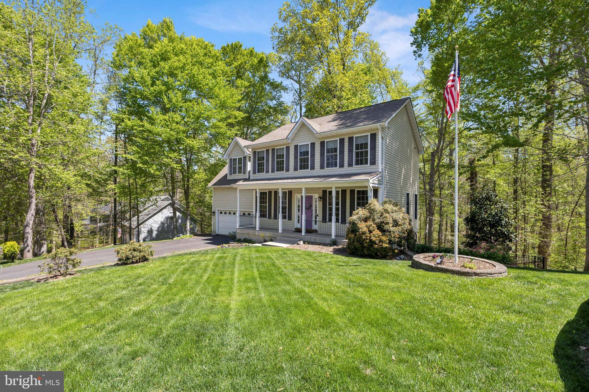 This beautifully maintained Colonial offers three finished levels of living space and nestled on a picturesque, wooded lot. The original owner has taken great pride and care both inside and out where you'll find numerous updates throughout, blending timeless character with modern convenience. The main level greets you with warm hardwood floors & ceramic tile accents, a main level study with built-ins, dining room and a completely modern, updated kitchen with center isle and wet bar. The adjacent family room offers sweeping views of the private rear yard and easy access to the multi-level deck. The rear staircase leads to the upper level boasting warm and comfortable finishes to include the updated primary bedroom with engineered bamboo floor and private ensuite bath boasting a seperate soaking tub and shower stall.  Spacious secondary bedrooms, a beautiful updated hall bath plus full laundry room complete this level. The fully finished walk-out basement includes a private in-law suite complete with its own kitchen, full bedroom, bath and rec room—perfect for multi-generational living, teen suite or guests. Updates...2018 Master BR and Baths, 2020 Full Kitchen Update w/Appliances & HVAC System, 2022 Deck. This home combines comfort, functionality, and classic style in a serene setting. Located in amenity filled Presidential Lakes with access to several community lakes, fishing, swimming, picnic pavilions and tot lots plus close to Dahlgren, Downtown Fredericksburg, Hiking Trails, Wineries and more.