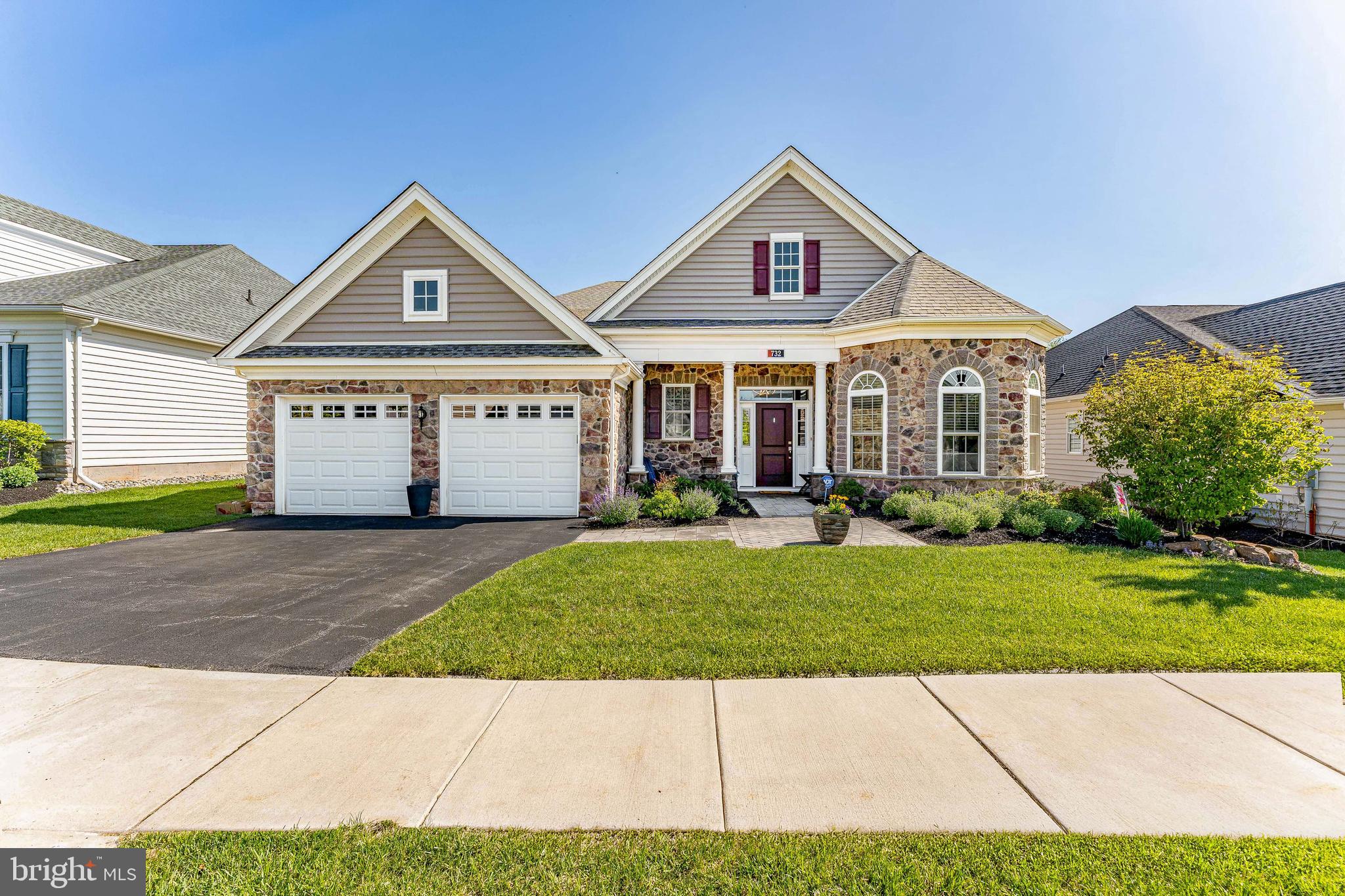 Welcome to 732 Reading Circle, a 2-bedroom, 2-bath home with a dedicated office, located in the 55+ community of the Regency at Kimberton Glen in Phoenixville. A two-car driveway provides convenient access as you arrive. Inside, the foyer features engineered hardwood flooring and a tray ceiling, creating a welcoming entry. Just off the foyer, a secondary bedroom with carpet flooring and a ceiling fan is located next to a full bathroom with tile flooring and a tub and shower combination. A laundry room with tile flooring and a utility sink is also conveniently positioned on this level, as well as garage access. The home office, set behind double doors, offers engineered hardwood flooring, a ceiling fan, and custom built-in cabinetry with a desk and integrated lighting, creating a functional and polished workspace. The main living area is designed for both comfort and entertaining, with a custom bar area featuring crown molding that opens to the family room and kitchen. The family room includes crown molding, a gas fireplace with a floor-to-ceiling stone surround, and access to the patio. The kitchen is well-appointed with an island with seating for 6, and pendant lighting, stainless steel appliances, a double sink, and a pantry with custom shelving and pull-out drawers by Closets by Design. Thoughtful details like soft-close cabinetry, under-cabinet lighting, and a two-zone wine refrigerator,  add both convenience and style. The adjacent dining area features a custom ceiling light and also provides access to the outdoor space. The backyard is a standout feature, offering a custom-built bar with a refrigerator and gas grill, along with two seating areas, one of which is covered by a pergola, creating an ideal setting for relaxing or entertaining. The primary suite includes carpet flooring, a tray ceiling with a ceiling fan, and a custom walk-in closet by Closets by Design. The en-suite bathroom features tile flooring, double sink vanities, and a spacious walk-in shower. Additional storage is available with attic access via stairs from the garage. This home is also equipped with a full house generator and an outdoor sprinkler system. Residents of the Regency at Kimberton Glen enjoy access to a private clubhouse and a low-maintenance lifestyle. The home is conveniently located near local shopping, grocery stores, restaurants, and just a short drive to downtown Phoenixville and major highways. Don’t miss the opportunity to make 732 Reading Circle your new home.