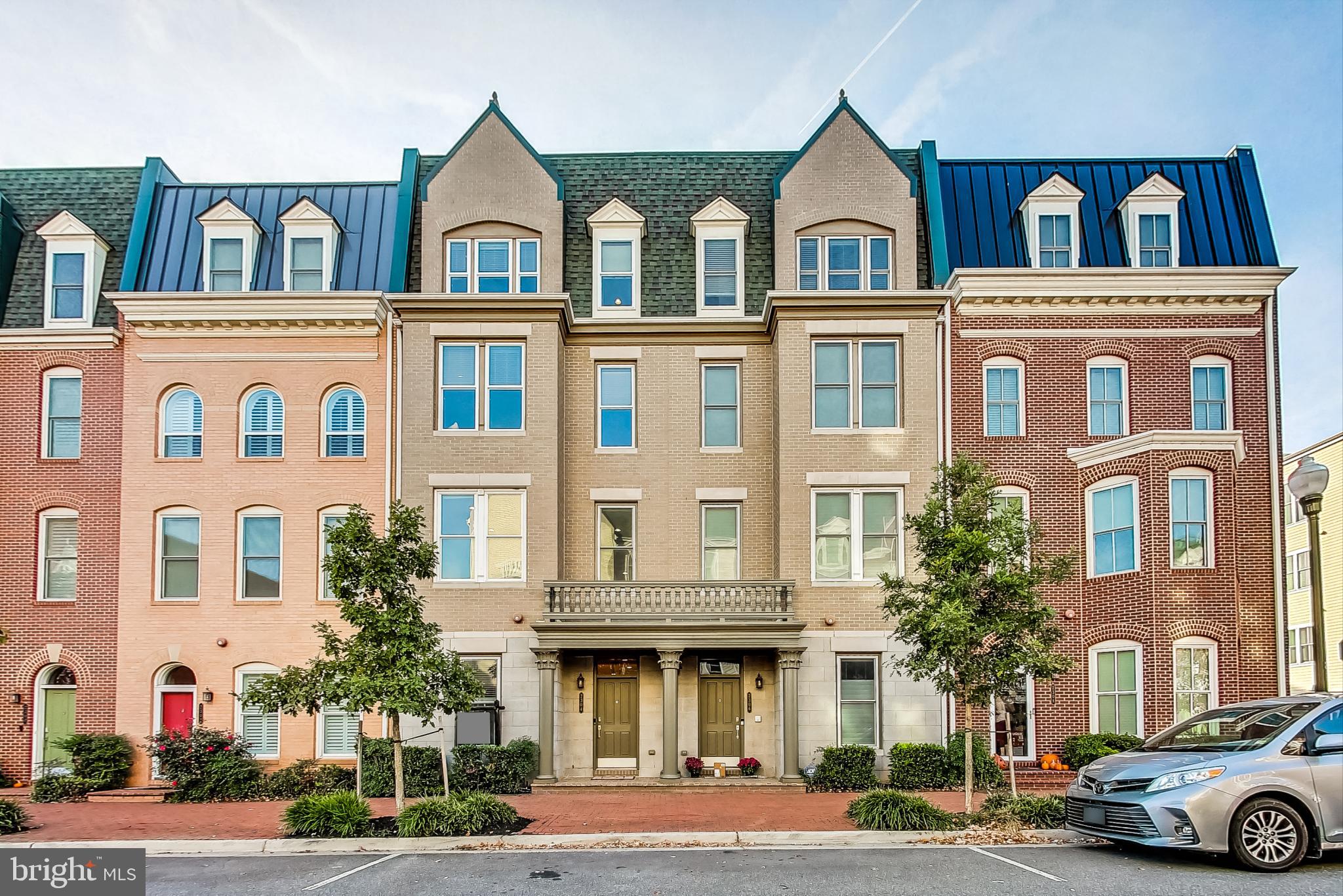 Welcome home to the desirable community of Potomac Yard! You owe it to yourself to see this stunning 4-level townhome! This gorgeous residence is the picture of modern elegance, with unique architectural features and high-end finishes together in one of the most convenient and popular spots in Northern Virginia. The entry level boasts a light-filled living room and large dining room, with beautiful hardwood floors, a cozy gas fireplace, and a show-stopping stone accent wall. Inside the sophisticated gourmet kitchen you’ll discover an abundance of rich wooden cabinets, sleek granite countertops, a classic tile backsplash, and stainless steel appliances - including a double wall oven. With the peninsula bar opening directly into the dining room, this level of the home is ideal for entertaining. Upstairs, the luxurious primary bedroom suite is vast, with large windows, recessed lighting, and multiple massive closets. The indulgent en suite bathroom features an oversized frameless glass door shower and an extra wide double sink vanity with plenty of cabinet storage. A bonus room completes this level, making it the perfect home gym, office, or add a door to create a 5th bedroom. Up a flight of stairs, the third level of the home includes two bedrooms with plush carpeting and ceiling fans, plus a handsome full bathroom in the hallway. The top level offers a third full bathroom and fantastic bonus living space and a full wet bar, convenient for entertaining while enjoying breathtaking views of the city from the privacy of your own rooftop patio. Adding to the home's versatility is a fully finished carriage house above the two car garage, with a private entrance, full bath, and kitchenette - ideal for a separate home office, au pair suite, or guest suite. They’ll also enjoy shared access to your serene fenced brick patio for outdoor dining and relaxing. The new homeowner will get to enjoy the peace of mind that comes along with two brand new HVAC systems. This popular community offers an abundance of amenities including a dog park, playground, jogging and biking trails, and basketball and tennis courts. Plus you will be located close to everything you can think of! Minutes to Harris Teeter, Target, Fashion Center at Pentagon City, Old Town Alexandria, Del Ray, The Pentagon, Amazon HQ2, and Reagan National Airport. Quick access to Potomac Yard and Pentagon City Metro Stations, Route 1, I-495, I-395, and the GW Parkway makes commuting and getting around the DMV a breeze. This stunning home in such a desirable location won’t be available for long! Schedule a private tour and enjoy the holiday season in your impressive new home!