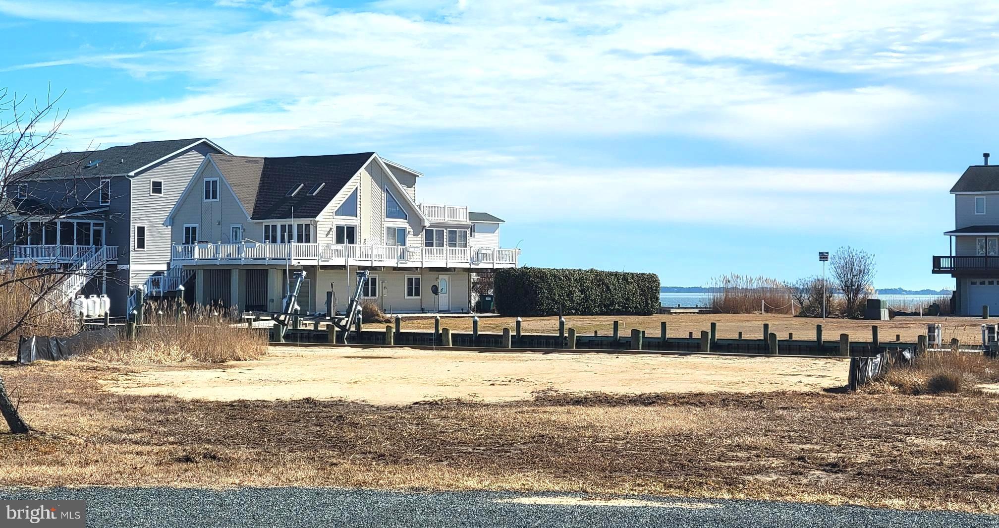 Breathtaking views of the Chincoteague Bay, a front row seat to rocket launches and a protected canal where you can dock your boat 20 feet from your home. This large (15,367 sq ft) cleared, freshly leveled lot with BRAND NEW BULKHEAD has 105 feet of waterfront facing the Chincoteague Bay. Located in  the amenity rich community of Captains Cove featuring 2 outdoor pools, 1 indoor pool, fitness room, golf course, community boat ramp, dog park, tennis, pickleball, and a Marina Club Restaurant that features live entertainment. Captains Cove is located a short ride from Chincoteague Island, VA and Ocean City, MD. This lot has water and sewer availability and NO BUILDER TIE-IN, so take your time to design and build your waterfront dream home.