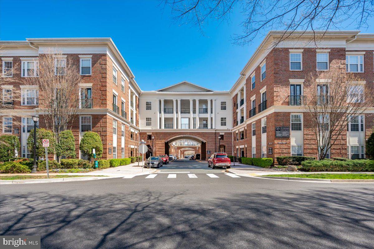Welcome to your loft penthouse residence at the Colonnade in Kentlands. This rarely available condo offers an unmatched lifestyle filled with light, luxury, and convenience.
Step inside to find a light-drenched living area featuring soaring 20-foot ceilings, massive windows, and beautiful hardwood floors. The open dining and living layout flows effortlessly into a charming loft space equipped with a large closet. You can easily transform this versatile area into a home office, yoga studio, music room, or cozy TV nook.
Just off the living room, step out onto your private balcony. Designed for total privacy away from neighboring balconies and skywalks, it gives you unobstructed panoramic views of stunning pastel sunsets and sunrises. It is the perfect spot for your morning coffee or evening happy hour.

The thoughtful architectural layout features two complete, private bedroom suites. Each suite includes its own full bathroom and walk-in closet, giving you plenty of personal space while enjoying life together. You will also love cooking in the updated kitchen, which features granite countertops, stainless steel appliances and a spacious pantry.

Property Highlights & Amenities:

Premium Upgrades: Enjoy an in-unit full size washer and dryer, a newer water heater (2022), and two reserved indoor garage parking spaces.

Resort-Style Amenities: Access a private outdoor swimming pool, a two-level gym, a theater room, a sauna, a library, and Max’s Pub (featuring billiards, games, and a bar).

Striking Architecture: Walk through visually stunning corridors connected by open-air sky-bridges. The classical, airy design makes coming home a true joy.

Prime Location: Walk less than a half-mile to Whole Foods, Giant, excellent restaurants, boutique shopping, and scenic walking or biking paths.

Experience the peak of convenience and quality of life in a building unlike any other in the Kentlands or Lakelands. This rare loft penthouse is available right now. Schedule your private tour today to make this stunning home your own.