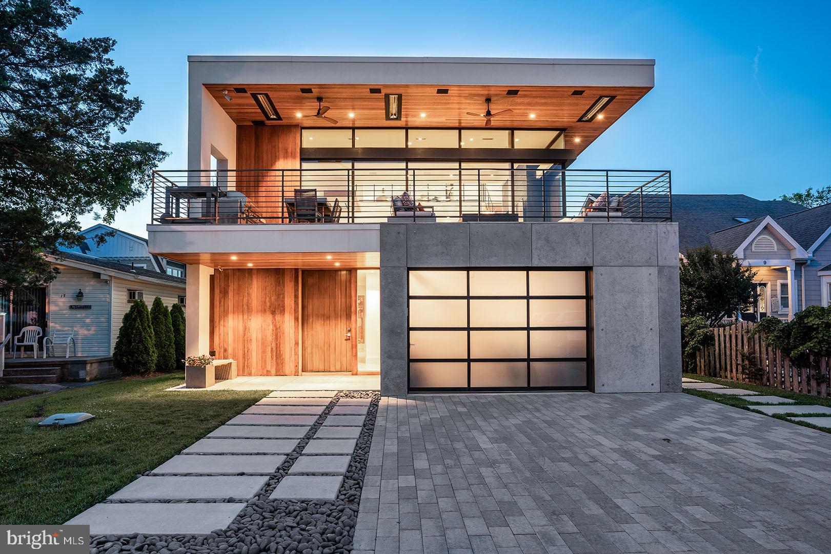 Welcome to 15 Cullen Street, a modern masterpiece located in the ocean block of the highly desired neighborhood known as Rehoboth by the Sea. Renowned architect, Randall Mars, carefully blended the ideal coastal setting with flawless design and sophistication. Situated only steps from the ocean, this stunning residence features a total of 5,500+/- square feet including 5 bedrooms, 6.5 bathrooms and casually elegant living spaces on each of the home’s three levels. Upon entry, clean lines, tasteful décor make a dramatic impression. The first level features 4 spacious bedrooms with luxurious spa-like baths, a spacious living area complete with wet bar with quartz counters and refrigeration. In addition, a mudroom with direct access to the outdoor shower and a 1-car garage, perfect for bikes and storage. Rich walnut stairs guide you to the main level (2nd) where you will find a spectacular great room complete with polished concrete floors, soaring ceilings and a sleek fireplace with marble surround. The interior space is fluidly connected to the environment by floor to ceiling glass that completely opens to the expansive terrace with seating area, built-in fire pit, dining area and outdoor kitchen with gas grill and beverage center. The custom kitchen features stunning white cabinetry, stainless steel appliances and a window stretching the length of counter. The island is emphasized with gorgeous quartz counters with a waterfall edge and range hood artfully built-in a walnut accent piece. The space is finished with a dining area, wine storage and beverage center. In addition, this level includes the primary suite complete with a custom walk-in closet and a luxurious and sleek private en-suite bath. Perched on the third level is a superior flex space currently being utilized as an executive office. This generously sized room includes a full bath, private balcony and direct access to the sundeck boasting superb ocean views. The home is visually striking, and the systems are equally as impressive. With top-notch security and surveillance, audio/video, and smart home technology throughout, you can manage everything remotely from a mobile device. This home includes many features that could not duplicated under today’s building code, and it is truly a one-of-a-kind opportunity. All situated in a sought-after location offering one of the most gorgeous beaches along the Delaware coast. This home truly leaves little to the imagination!