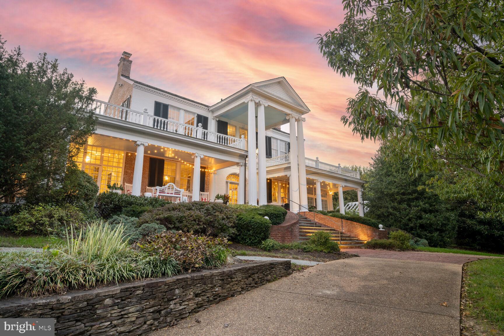 Welcome to  Mt. Ida, an exquisite single-family home in the heart of Alexandria, VA. This historic home was built in 1808 by Charles Alexander, Jr. - a sixth generation from John Alexander, after whom Alexandria was named. Spanning over 6,000 square feet, this detached residence offers an unparalleled blend of luxury and comfort. With five spacious bedrooms and four full and three half baths, this home is designed to accommodate both intimate family living and grand entertaining.

Step inside to discover architectural elegance featuring built-ins, columns, crown and decorative moldings, and exposed brick. The high ceilings and eastern exposure flood the home with natural light, accentuated by floor-to-ceiling and oversized windows with tasteful treatments. The ambiance is further enhanced by chandeliers and recessed lighting throughout.

The chef's kitchen is a culinary dream, boasting a breakfast bar, marble counters, and premium stainless steel appliances, including a gas stove and side-by-side refrigerator. The open kitchen design flows seamlessly into an eat-in area and formal dining room.

Relax in the expansive living spaces, with six working fireplaces, a library/den, a music room, and a home office. The primary suite is a sanctuary featuring a walk-in closet, exercise area, ensuite with separate shower and soaking tub, and windowed bathroom.

Outdoor living is equally impressive, with a private roof deck, back and front yards, patio, and porch. Enjoy panoramic river and garden views from every angle. Additional amenities include a basement, an attached two-car garage, a circular driveway with ample parking, and a security system,

Experience luxury living at its finest in this Alexandria gem.