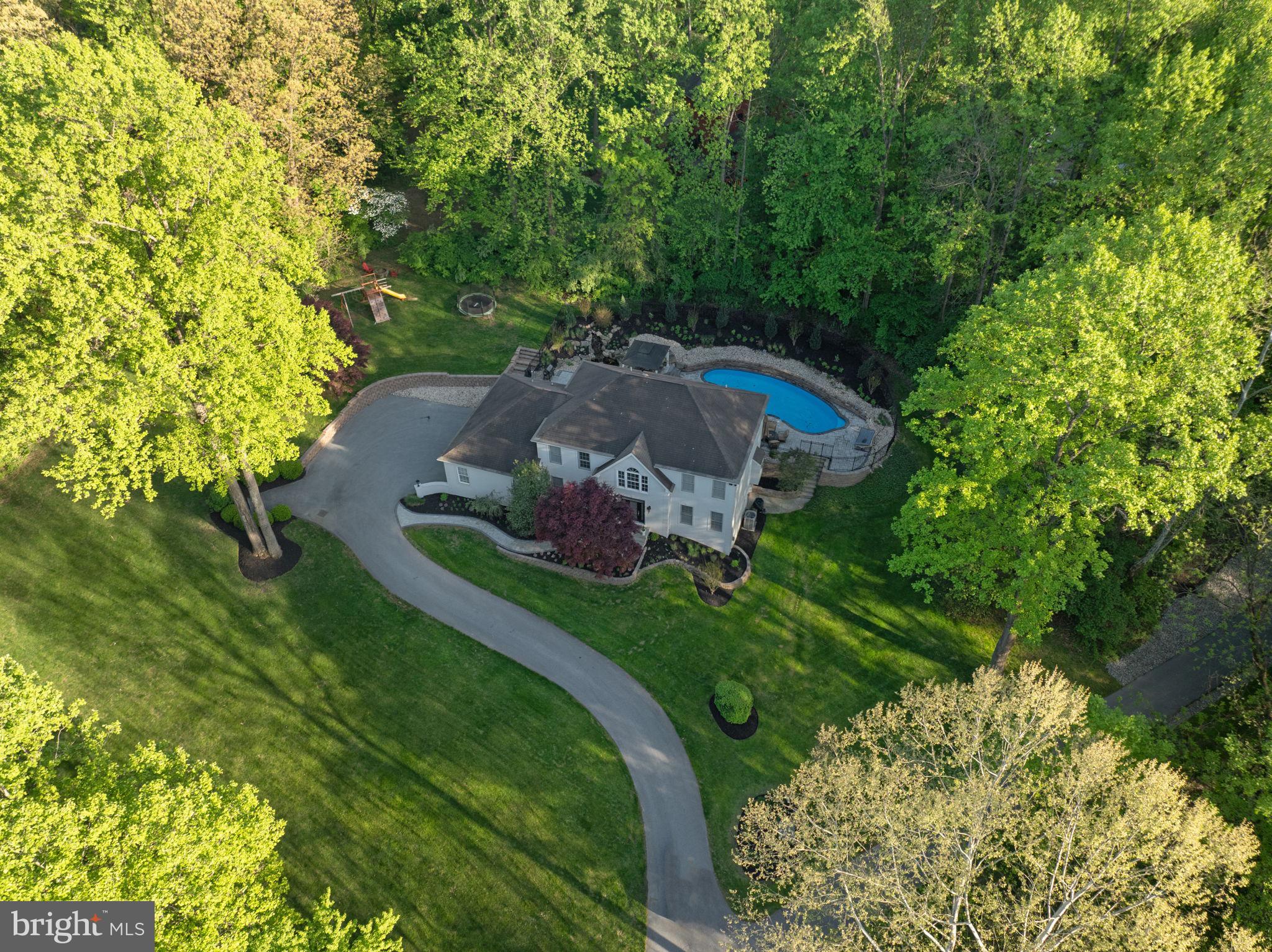 West Chester School District! A beautiful custom-built home situated on 1.3 private acres in the scenic hills of East Bradford Township, just minutes west of West Chester Borough & walking trails. This Updated home offers a thoughtful floor plan with 3 bedrooms and 2 full baths on the second floor, plus a finished walkout lower level featuring a 4th bedroom, full bath, recreation/family room, custom cabinetry, French doors, and generous storage. 
The main level features porcelain flooring thru out, 2-story foyer, large first-floor office, 2024 updated custom kitchen cabinetry, Sub-Zero refrigerator, new countertops, wine cooler, island workspace, breakfast room, extensive trim accents, wainscoting, plantation shutters, tile flooring, and a gas fireplace. The spacious primary suite offers a tray ceiling, hardwood flooring, sitting area, walk-in closet, and tile bath with soaking tub, double vanity, and separate shower. Built for entertaining, the outdoor space includes a heated in-ground pool with spa, all new bluestone paver patio, new pavers around the pool & front walkway, paver firepit area, beautiful waterfall, shed, and peaceful natural surroundings. Additional highlights include a heated 3-car side-load garage and full-size second-floor laundry.
Enjoy quick access to Route 202, Route 30 Bypass, PA Turnpike, train station, and major commuting routes. Just down the street from Harmony Hill Nature Area for walking, hiking, biking, and outdoor activities. A rare private setting in a highly desirable West Chester location.