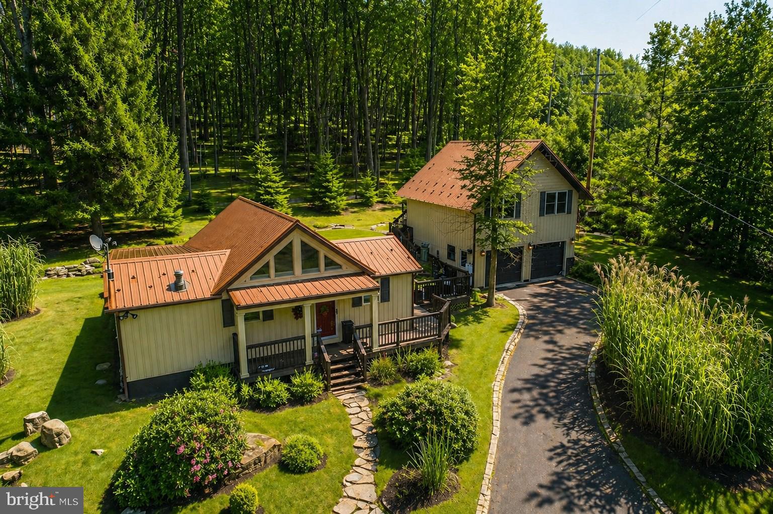 Welcome to this exceptional 2-bedroom 2-bathroom home with a separate 2-bedroom 1-bathroom apartment/in law suite  offering a rare blend of privacy, recreation, and modern updates. Set on a beautifully landscaped property with its own small private pond. Property is located just minutes from ski access at Wisp Resort. The exterior has been thoughtfully updated with a durable new metal roof and updated siding, enhancing both curb appeal and long-term peace of mind. Extensive outdoor landscaping creates multiple spaces to relax, entertain, and enjoy the natural surroundings, while on-site hot tub hookups provide the perfect opportunity to create your own private retreat. A detached garage offers ample space for vehicles, storage, or lake toys. Inside, the home features a functional and spacious layout ideal for full-time living or a vacation getaway. Whether you’re seeking a serene primary residence or a turnkey lake-area escape, this property delivers the lifestyle you’ve been waiting for—privacy, access, and modern improvements all in one remarkable setting. Contact today to schedule your private tour! Summer photos have been digitally enhanced using AI.