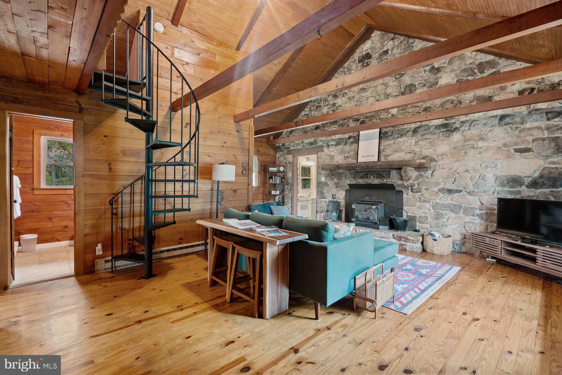 Welcome to 105 Apache Trail, a beautifully updated cabin in Shawneeland offering privacy, character, and flexibility for full time living, a weekend escape, or income potential. 

Set on a level wooded lot, this home features a floor to ceiling stone fireplace with wood burning stove, exposed beams, and warm, inviting finishes. The main level includes two bedrooms, a full bath with in-unit laundry, and an updated kitchen with gas cooking, new countertops, stainless appliances, and an added dishwasher. 

The renovated loft serves as a spacious primary retreat with new LVT flooring, skylight, closet, and dedicated HVAC. 

Recent upgrades include kitchen and bath renovations, loft improvements with added HVAC, spray foam roof insulation, septic upgrades, new washer and dryer, updated lighting, a new storm door, and a new skylight. 

Outdoor features include a fire pit area, storage shed, and covered carport, creating a great setup for relaxing, entertaining, or enjoying time outdoors. 

Located within the Shawneeland community, residents have access to amenities including a lake, playgrounds, and a 4 hole golf course, adding to the overall lifestyle appeal. 

Currently a successful short term rental with a 9.8 out of 10 rating on VRBO and a 4.87 out of 5 rating on Airbnb, along with over 100 five star reviews across both platforms. The home is not being sold furnished, however furnishings may be available separately for a turnkey setup. 

Convenient to Winchester, hiking trails, and Shenandoah Valley attractions, with easy access to Northern Virginia, Maryland, and DC.

This property is part of the Shawneeland Sanitary District