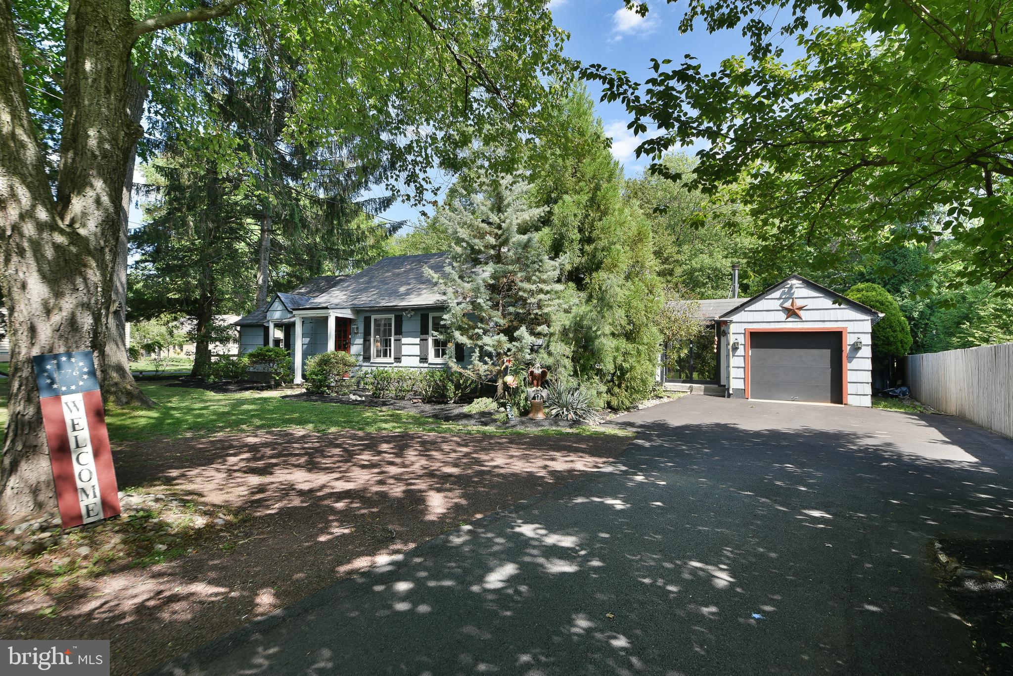 Nestled on a beautiful half-acre lot in Buckingham Township, this truly special ranch style single-family home offers charm, character, and exceptional outdoor living - with one level living! Complemented by a timeless slate roof, this home welcomes you with a living room featuring a fireplace and a dining room with a bay window overlooking the expansive deck and picturesque backyard. The updated kitchen is a chef's delight, boasting wood cabinetry with glass-front accents, a pantry cabinet, stainless steel appliances, dishwasher, beverage/wine refrigerator, dual refrigerator drawers, glass-top cooktop and built in oven, stainless steel sink with a drain board and butcher block countertops.

The spacious main level also includes a large breakfast area that opens to an impressive family room featuring hardwood floors, a cozy wood stove, and sliding glass doors leading to the rear deck, along with a second set of doors providing access to the front yard and driveway. Two bedrooms with hardwood floors include a generously sized primary bedroom and a second bedroom currently used as a home office. The oversized bathroom offers a double vanity, corner shower stall, creating a bright and open retreat. A large walk-in closet in the hallway and multiple storage closets near the living and dining areas provide abundant storage throughout the home.

Outdoor living is equally impressive. Relax beneath the pergola with shade cloth, entertain on the expansive deck, or enjoy the two-year-old gazebo overlooking the beautifully fenced backyard filled with lush, mature landscaping. Additional features include an oversized one-car garage with inside access and a large storage area, a spacious storage shed, some replacement windows, newer heating and central air conditioning systems, and a newer water heater,  and a basement that offers endless opportunities for storage and potential additional living space with your finishing touches.

Conveniently located just minutes from Doylestown, New Hope, and Peddler's Village, you'll enjoy easy access to exceptional dining, boutique shopping, parks, and cultural attractions, along with convenient access to major roadways for commuting. This unique property offers the perfect combination of comfort, character, and outdoor enjoyment.