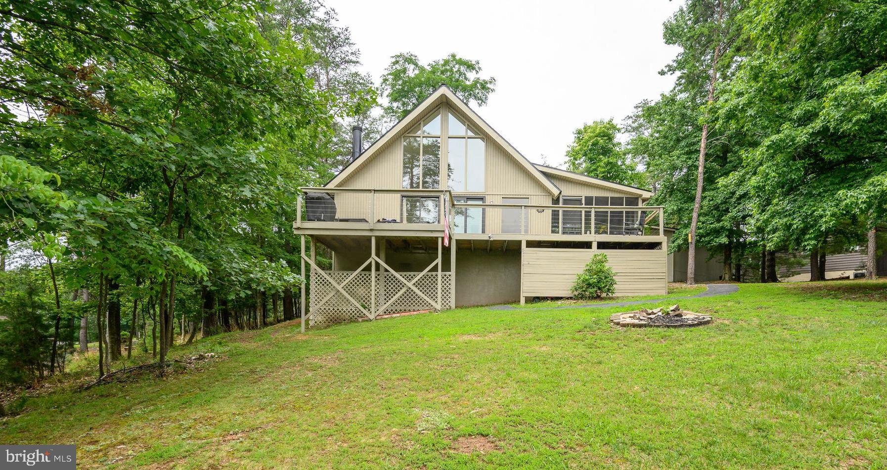 "LIVE WHERE YOU PLAY" and "BE ON VACATION EVERY DAY!" Welcome to your Dream retreat in The Woods Resort!! If you're looking for a house with amazing views of a beautiful golf course or the majestic mountains in Maryland, stop right here... this 3-bedroom, 2 bath chalet is for you! We are move-in ready with new flooring, new appliances and granite counters and much more! This beautiful Elmwood model also boasts A HUGE 2-car detached garage, a screened porch and 2 large decks for entertaining! The roof was recently replaced, new windows have been installed, and the interior and exterior have just been painted. It's within WALKING DISTANCE to all amenities... the golf course, pool and dining! If you are looking for a weekend getaway or a fulltime residence, you need to take a look at this property. The Woods is not just a community, but a wonderful lifestyle change! Come see! Located approximately 90 minutes from both Washington, DC and Baltimore, the property offers the kind of privacy, space, and natural setting that appeals to those who want a calmer, quieter life.