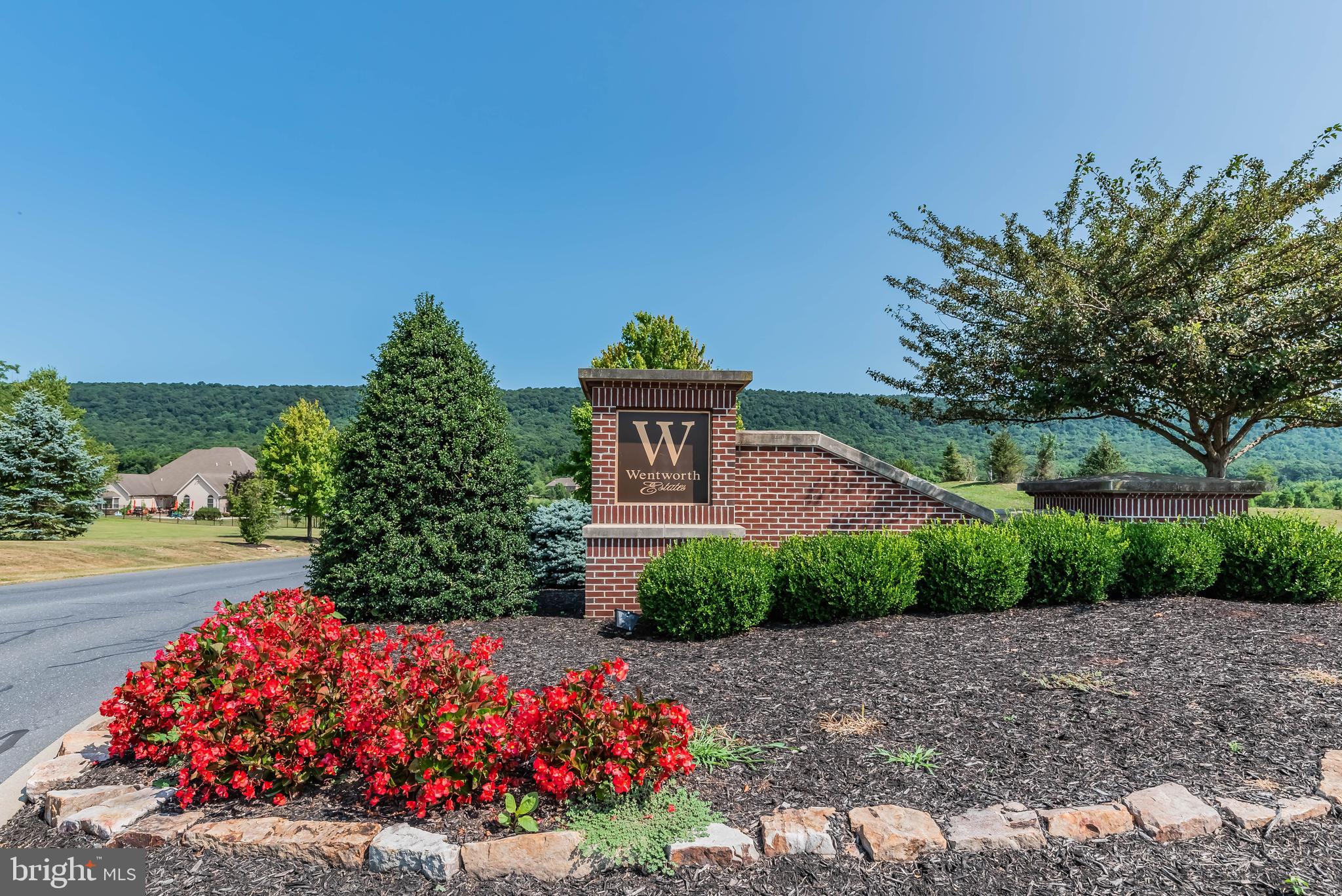 Nestled in the prestigious community of Wentworth Estates, this exceptional residence offers the rare opportunity to truly have it all—luxury, space, privacy, and versatility—all in one remarkable home.

Boasting 6 bedrooms, 5 full baths, and 2 half baths, with over 6,000 square feet of beautifully appointed living space, this stately home is designed to impress while providing the comfort and functionality today’s discerning buyers desire.

At the heart of the home is a chef-inspired gourmet kitchen, thoughtfully designed with abundant custom cabinetry, expansive granite countertops, premium Viking stainless steel appliances, a dedicated pantry, and exceptional storage throughout. Offering outstanding prep and cooking space, the kitchen seamlessly flows into a cozy sitting room anchored by a gas fireplace—creating the perfect setting for both everyday living and intimate gatherings.

The thoughtfully designed main level also features a private home office, convenient first-floor laundry, and a desirable first-floor primary suite. The primary bedroom offers a generous layout, a large walk-in closet, and a well-appointed ensuite bath featuring a tiled walk-in shower and soaking tub.

Elegant details are found throughout, including gleaming hardwood floors, refined finishes, and abundant windows that flood the home with incredible natural light. The dramatic two-story family room, highlighted by soaring ceilings and a gas fireplace, creates a stunning focal point and overlooks the rear patio and serene backyard.

Enhancing the home’s versatility is a private bonus suite with its own entrance and full bath, offering exceptional flexibility as a guest retreat, multigenerational living space, private office, au pair suite, or studio.

The unfinished lower level presents endless possibilities, offering substantial space to create a home theater, fitness studio, wine cellar, recreation room, or additional living area tailored to your lifestyle.

Situated on a beautifully manicured lot with private wooded rear views, the outdoor setting offers the perfect balance of privacy and recreation. Whether hosting gatherings on the patio, enjoying the expansive yard, or designing the luxury pool oasis of your dreams, this property provides the space and setting to bring your vision to life.

A rare offering in one of the area’s most sought-after communities, this extraordinary Wentworth Estates home delivers timeless elegance, exceptional scale, and endless possibilities.