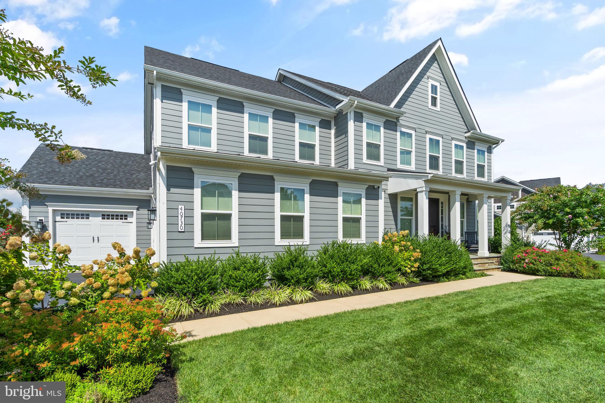 Welcome to 40730 Willow Walk Ct, a stunning 5-bedroom, 5-bathroom home in the sought-after Greens of Willowsford. With over 5,224 sq. ft. of living space on a landscaped .66-acre estate lot, this NV Homes Marymount model offers style and functionality in the Hovatter/ Henrietta Lacks ES, Willard MS, and Lightridge HS Cluster. The main level features a gourmet kitchen with white cabinetry, quartz countertops, stainless steel GE Profile appliances, double ovens are wifi with air fryer built in, a large pantry wtih customm organizers, and an extended island. Additional highlights include two home offices, a guest bedroom with a full bath, a family room with recessed lighting, and a 3-seasons deck with a fireplace. Wide plank LVP floors run throughout all three levels.  Upstairs, the primary suite includes two walk-in closets, a spa-like bath with a soaking tub, dual shower heads, and double vanities. The upper level also has three more bedrooms all with walk in closets, two full baths, and a convenient laundry room. The finished basement is perfect for entertaining with luxury vinyl plank flooring, a dry bar, a hidden kids’ nook, and plenty of storage.  Outdoors, the .66-acre yard features a patio, fire pit with outdoor movie screen area, play set, playhouse, shed, permanent holiday lights, sprinkler system with wifi controller, and mature landscaping. The 3-seasons deck with fireplace offers space to relax or entertain year-round.  The home offers a spacious 3-car garage equipped with dedicated charging outlets for each vehicle. Custom trim work throughout the home.  Custom Container Store closets in bedrooms, mudroom, pantry and coat closets.   The amazing Willowsford  Community is a resort-style community offering numerous amenities, including multiple Community Pools, Two Clubhouses, Fitness Center, Community Events, Cooking Classes, Kids Programming, Zip Line, Tree Houses, Lakes, Boat House, Canoes, Fishing Ponds, Splash Park, Disc Golf, Dog Parks, Willowsford Farm, 44 miles of Trails, 2,000+ Acres of Conservancy, Farm Stand, CSA, and more! Willow Walk Ct is a mile from Lodge Clubhouse with features 3 pools, fitness center, boat house, lake, community park, 4th of July fireworks, and many signature events. Enjoy easy access to Dulles Airport, Shopping, Restaurants, Vineyards, Commuter Routes, and Metro Rail.