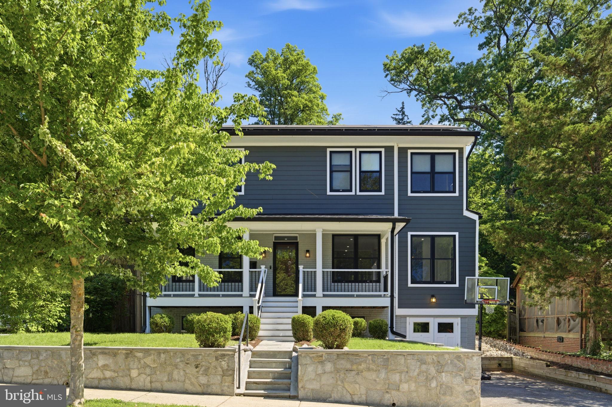 Open house Saturday 6/6, 12-2PM. This spectacular reimagined 5-bedroom, 4.5-bath home, expanded and extensively renovated in 2017, is located in a desirable Silver Spring neighborhood just outside Takoma Park, blending timeless character with today’s luxury finishes and modern conveniences.  The striking exterior features contemporary railings, Hardie Board siding, composite decking, and stylish, black-framed windows that create exceptional curb appeal. Inside, the main level offers an open-concept floor plan ideal for everyday living and entertaining. The gourmet kitchen showcases upgraded cabinetry, marble countertops and backsplash, stainless steel appliances including a gas range, a large center island, and an expansive table area. Flowing seamlessly from the kitchen is a spacious family room with a gas fireplace overlooking the magnificent backyard. Beautifully maintained solid wide-plank hardwood flooring runs throughout the main level. The main level also includes a perfect den or office space that can easily serve as a fifth bedroom, along with a large living room off the welcoming entry foyer. Step outside to a composite deck overlooking an expansive paver patio and beautifully designed multi-tiered backyard offering endless possibilities for entertaining or relaxation. The upper level features a luxurious owner’s suite with solid wide-plank hardwood flooring and a spa-inspired en-suite bath with beautiful tile work and a custom walk-in shower. Three additional generously sized bedrooms complete the upper level, including one with a private en-suite bath, while the remaining two share a well-designed Jack-and-Jill bathroom. The finished basement offers a large recreation room, an additional full bath, and an older-style smaller garage ideal for storage. The roof and major systems are approximately seven years old, including seller owned solar panels (not leased) that result in annual electric savings and two HVAC systems serving separate zones for enhanced comfort and efficiency. The solar system is owned by the Seller free and clear and transfers to the buyer and check out the electric savings they had in the last year! You can’t beat the location — just moments from Sligo Creek Park, close to downtown Silver Spring, and just outside Takoma Park — offering exceptional convenience for commuting into and out of Washington while enjoying some of the area’s most vibrant dining, shopping, and outdoor destinations.