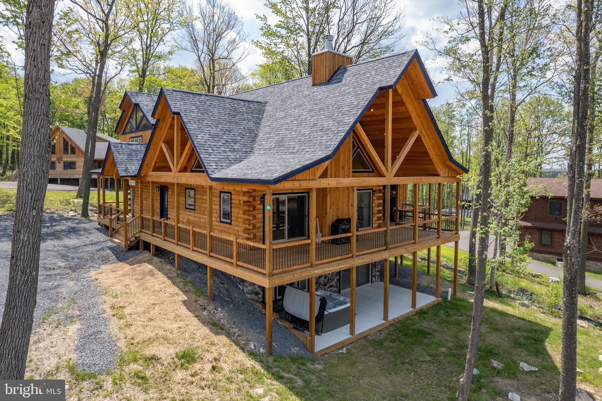 Newly completed in 2025, this stunning 5-bedroom, 5.5-bath mountain retreat blends upscale finishes with the natural beauty of Deep Creek Lake. Located in the sought-after North Camp community atop Wisp Mountain, the home offers spacious open-concept living designed for both relaxation and entertaining. Warm wood accents, soaring ceilings, and a beautiful stone fireplace create an inviting atmosphere throughout the main level. Well-appointed kitchen flows seamlessly into the main gathering areas, while multiple living spaces provide plenty of room for family and guests. After a day enjoying nearby skiing, hiking, golf, and Deep Creek Lake activities, unwind in the private hot tub or gather around the covered outdoor fireplace. Ideally situated just minutes from Wisp Resort, Deep Creek Lake, State Parks, and countless year-round recreation opportunities, this property offers the perfect balance of luxury, comfort, and adventure in the heart of Garrett County.