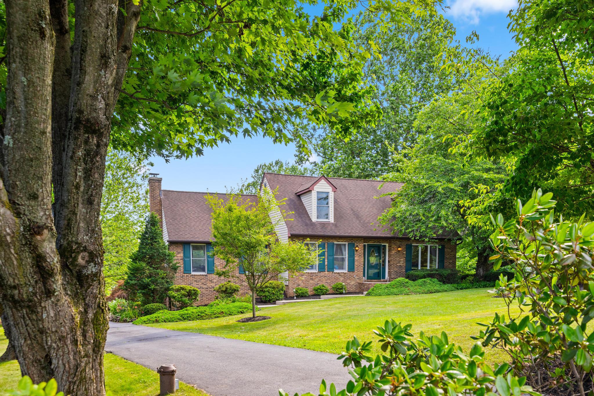 Swooning over this gorgeous Cape Cod, privately tucked in the back of a cul-de-sac in the highly desirable neighborhood of Glen Elyn. This beautifully renovated home blends timeless charm with modern sophistication, offering thoughtful updates and inviting spaces throughout. Featuring 3 bedrooms, & 2.5 baths, this residence welcomes you with a custom renovated kitchen showcasing quiet-close cabinetry, moody granite countertops, and stainless steel appliances. The oversized family room is truly a showstopper, boasting vaulted ceilings, stunning wood beams, and panoramic views of the serene, tree-lined backyard. Step outside to enjoy the expansive deck, a private fenced area, and peaceful surroundings that extend beyond the property with trails leading to 18 miles of scenic Gunpowder hiking. The main level laundry and mudroom provides everyday convenience with easy access from the backyard, while the fully finished basement offers additional living space and a private attached garage. Nestled in a sought-after community with a rare combination of privacy, character, and modern amenities, this exceptional Cape Cod offers a unique opportunity to enjoy a beautiful home surrounded by nature while still being conveniently located near everyday conveniences. 2025 New, Modern light fixtures installed 2026 Most recent updates include fresh paint, new carpet and HVAC extension to basement living area & Fresh Landscaping. This show stopper is waiting for you to move in!