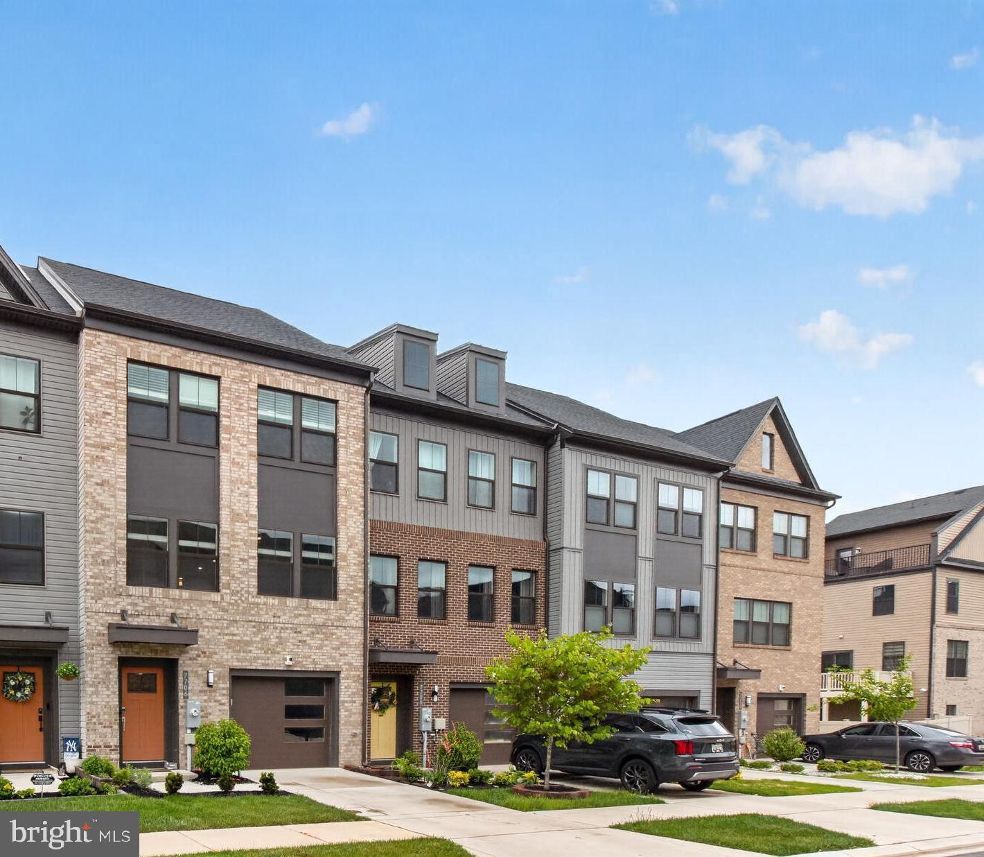 Built in 2022, this stunning brick-front 3-bedroom, 3 full, 2 half-bath townhome offers 2,140 square feet of beautifully designed living space, complete with a main-level balcony and an impressive rooftop deck, all within the sought-after Tanyard Shores community featuring exceptional amenities. The main level welcomes you with a spacious open living area adorned with luxury vinyl plank flooring, recessed lighting, and elegant crown molding throughout. At the heart of the home, the gourmet chef’s kitchen is a true delight, showcasing stainless steel appliances, gas cooking, a built-in microwave, sleek white cabinetry, and granite countertops. A massive center island anchors the space, offering the perfect setting for casual dining, entertaining, or gathering with guests alongside the expansive dining area. A conveniently located powder room adds everyday ease, while the low-maintenance composite deck just off the main level provides the perfect space for morning coffee or relaxing outdoors. Upstairs, the impressive owner’s suite features tray ceilings, a lighted ceiling fan, a spacious walk-in closet with added shelving, and a beautifully appointed en-suite bath complete with a dual-sink vanity with ample storage cabinetry and a walk-in shower with a built-in bench. Two additional bedrooms, each offering spacious closets and stylish accent chalk walls, share a hallway full bath complete with a tiled tub/shower combo. A conveniently located laundry closet on the upper level adds everyday ease and functionality. The penthouse level serves as a true retreat, featuring a versatile flex space complete with a powder room and direct access to the stunning rooftop deck, ideal for a rec room, entertaining space, or private home office. The rooftop provides a serene setting for evening stargazing and outdoor relaxation. The walkout lower level offers yet another flexible living space with a half bath and direct garage access, making it perfect for a home gym, theater room, study, or formal sitting area. With three separate outdoor spaces to enjoy, including a rear yard with the potential to be fenced, fresh air and outdoor living can be enjoyed from nearly every level of the home. An attached one-car garage and private driveway provide parking for up to two vehicles. Residents enjoy access to exceptional community amenities, including a clubhouse, fitness center, outdoor pool, picnic and lounge areas, playground, and dog park. Ideally located just off Arundel Expressway, the home offers convenient access to a variety of dining and shopping options, including Sprouts and ALDI, while remaining just a short drive to BWI Airport. This is low-maintenance living at its finest, don’t miss the opportunity to make it yours!