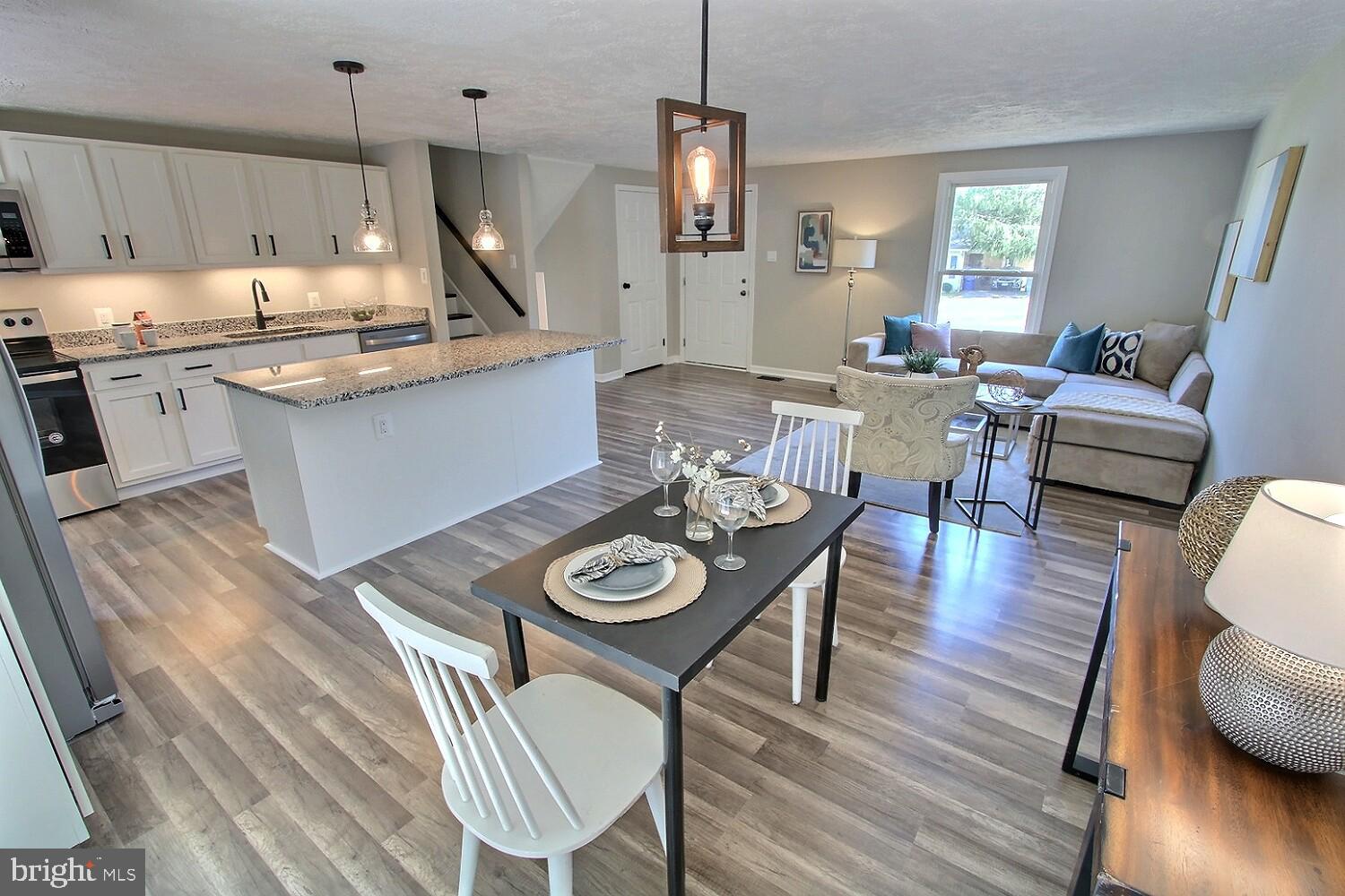 Offers due Monday Oct 4th 5:00. This is a beautifully renovated light filled home with an open floor plan.  Updated gourmet kitchen with new stainless steel appliances including dual zone wine fridge and new granite countertop. The kitchen opens to a bright and open living room. A tranquil rear yard features an above ground pool and backs to a wooded area for your privacy. A quaint deck is situated off the kitchen and opens to the pool for enjoying your morning coffee or tea. The lower level living room is open and features a wood burning fireplace. The upper level features two fully renovated bathrooms.  Updated LED recessed lighting throughout the home.