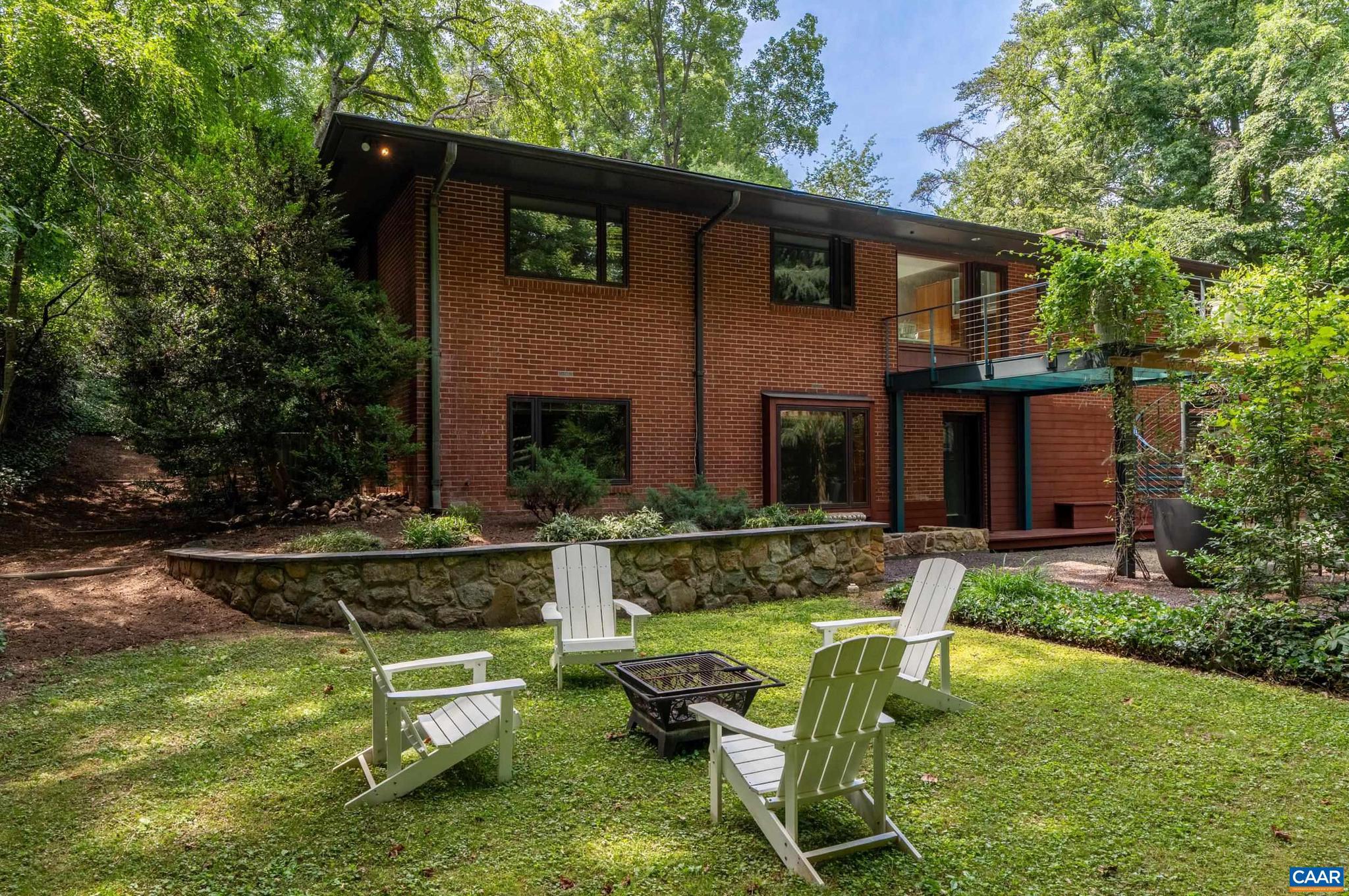 Originally reimagined by acclaimed architects Kenneth Schwartz and Judith Kinnard, former owners of the home, this unique residence reflects their commitment to thoughtful design, natural light, and connection to the surrounding.City convenience with a private, park-like setting, this 4-bedroom, 4-bath home is surrounded by mature trees and landscaping, creating a peaceful retreat just minutes from the University of Virginia, Barracks Road Shopping Center, and downtown Charlottesville. Comfortable one-level living, the main floor features spacious living areas, abundant natural light, and a well-appointed kitchen with a large center island, stainless steel appliances, and unique inlaid floor lighting. A bright sunroom overlooks the natural surroundings and provides additional living space year-round. The full walk-out basement offers exceptional flexibility with finished space for recreation, hobbies, guests, or a home office, along with ample unfinished storage. Outdoor living is equally inviting, with a stone patio featuring custom iron railings and beautifully established landscaping. The combination of privacy, mature grounds, and a highly convenient location makes this property a rare offering in Charlottesville.,Granite Counter,Stainless Steel Counter,Wood Cabinets,Fireplace in Living Room