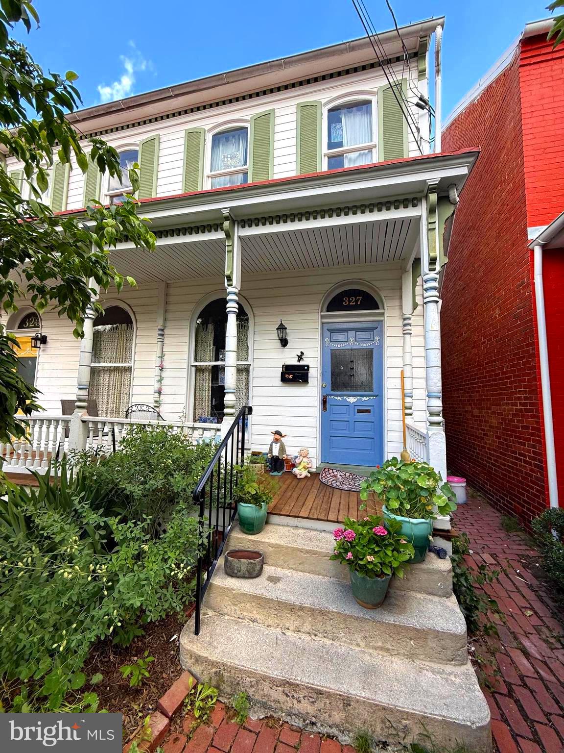 PRICED TO SELL in the heart of Downtown Frederick! Welcome to 327 E 3rd Street, a charming 3-bedroom, 1.5-bath home with storybook charm on a level fenced lot with parking, a backyard garden, a side walkway to the rear yard, and a welcoming front porch. 

The main level opens to the living room and continues to the dining room, kitchen, powder room, sunroom, and rear door leading to the yard and garden. The second level features two bedrooms, a full bathroom, a separate laundry room, and access to the summer balcony. The third level offers a spacious bedroom with added privacy, good storage, and an exposed brick chimney. 

Tucked away on a quiet street this home offers three levels above grade with a dirt floor basement and good storage throughout. It is full of character, natural light, and the walkable lifestyle that makes downtown living so special. 

Enjoy favorite local shops, restaurants, bakeries, breweries, galleries, Carroll Creek, parks, festivals, and community events just a short stroll from your front door. 
Start your morning on the sunny front porch, then step into the private fenced rear garden filled with a magnolia tree, perennials, and quiet little corners to relax, read, or garden. 

Rear alley access with parking adds valuable convenience for downtown living. Inside, this artist’s home is filled with natural light, creative character, and the warmth of a well-loved historic home. It is just waiting for your personal touches.