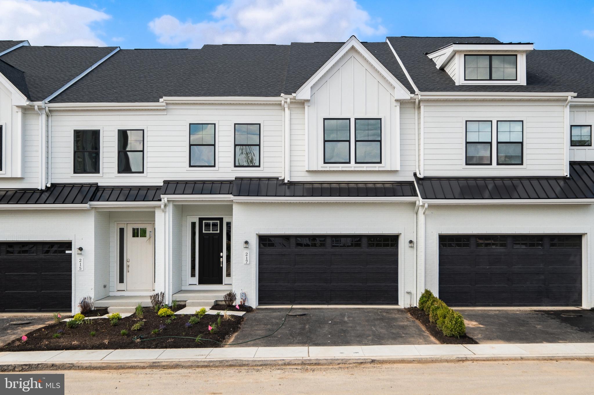 This quick move-in Harper Grand offers more than 3,000 square feet of beautifully finished living space, with three bedrooms, two-and-a-half baths, a two-car garage, and a finished walk-out basement. Elevated finishes, generous proportions, and a highly livable floor plan come together to create a home that feels both sophisticated and effortless.
A welcoming foyer opens to the heart of the home, where 10-foot ceilings and an open-concept design connect the kitchen, dining area, and great room in one seamless living space. The kitchen is a true focal point, featuring ceiling-height cabinetry in a refined organic-modern palette, soft-close doors and drawers, a large center island, and a walk-in pantry. A 36-inch gas cooktop sits beneath a custom wood hood, adding architectural character while anchoring the room with warmth and style.
The great room is filled with natural light from oversized windows that frame peaceful views of mature greenery beyond. That sense of privacy continues outdoors to the 10-by-20-foot deck, creating an easy extension of the main living area for morning coffee, quiet evenings, or relaxed entertaining. A dedicated first-floor study adds valuable flexibility, offering a private space for working from home, reading, or stepping away from the activity of the open living areas.
Upstairs, a spacious loft creates a natural gathering point between three bedrooms and a conveniently located laundry room. The owner’s suite is privately positioned at the rear of the home and features two walk-in closets and a spa-inspired bath with a dual vanity, walk-in shower, and private water closet. Both secondary bedrooms also include walk-in closets and share a well-appointed hall bath with dual sinks, an elevated detail that sets this home apart from typical new construction.
The finished walk-out basement adds another level of versatility, ideal for a media room, fitness space, playroom, guest area, or additional entertaining space.
Set within the vibrant River Trail community, this home offers the best of both worlds: natural surroundings, modern comfort, and everyday convenience. With quick access to major highways, you are just minutes from where you need to be while still coming home to a setting that feels private, peaceful, and connected to nature.