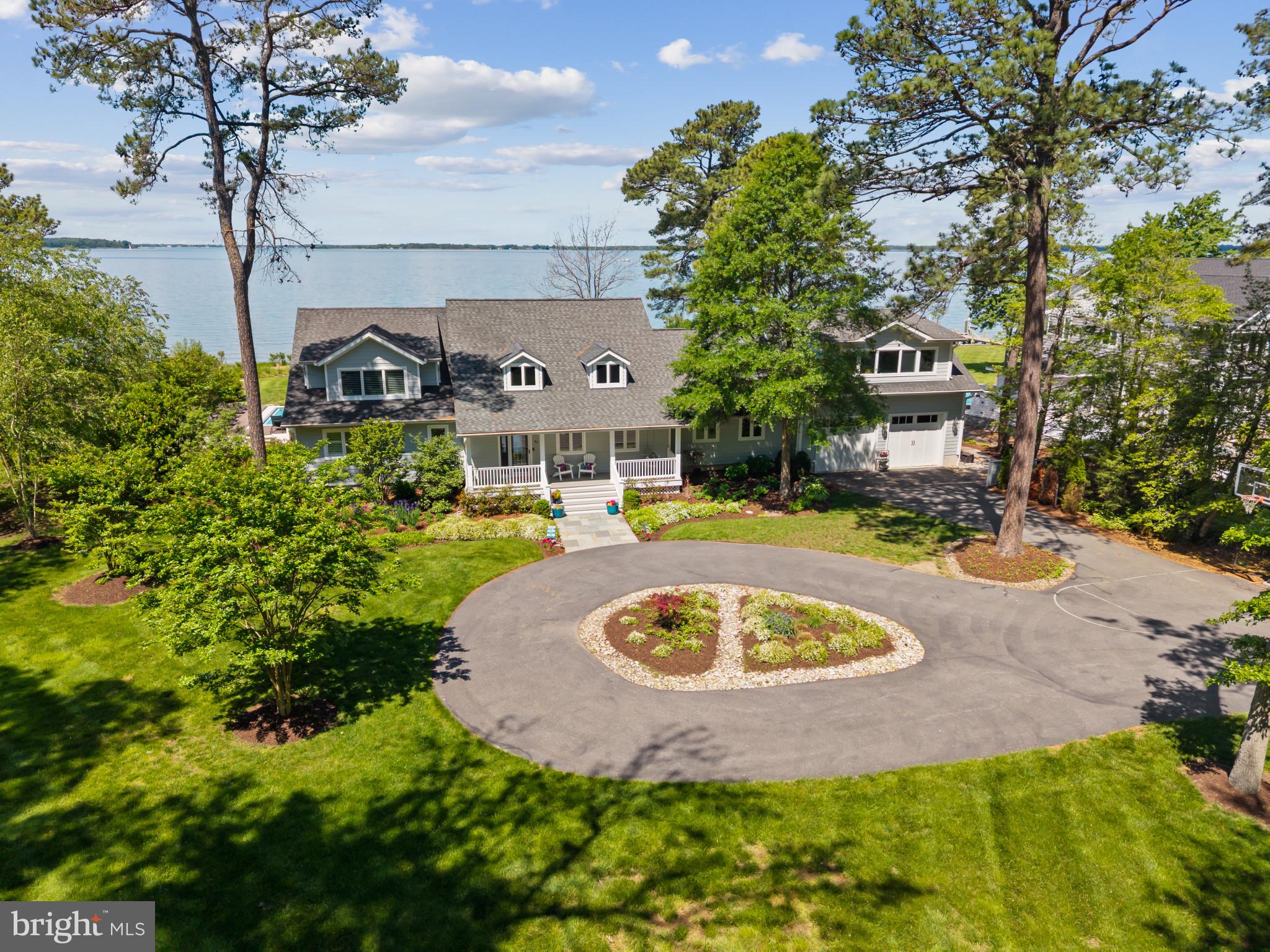 Experience luxury waterfront living in Prospect Bay! This five bedroom home blends timeless design with modern updates, offering the perfect balance of elegance and everyday functionality on the Eastern Bay. Thoughtfully renovated inside and out, it showcases stunning water views, high-end finishes, and a layout ideal for both daily living and entertaining.

Step inside to soaring ceilings, premium materials, and a flexible space perfect as a playroom or office. The open-concept main area impresses with panoramic bay views and a fully renovated gourmet kitchen featuring top-of-the-line appliances, custom cabinetry, and a spacious island that flows seamlessly into the dining and living spaces. A sleek gas fireplace adds warmth and style.

Off the kitchen, an oversized two-car garage connects to a new 30'x25' bonus room above—ideal as a media room, game room, or guest retreat. A mudroom with built-ins and a spacious laundry room provide practical access to the outdoors for easy poolside cleanup. A second laundry area is near the main-level primary suite.
The primary suite is a true retreat, reoriented to capture water views, and enhanced with a walk-in closet and spa-like en-suite bath with an oversized shower. Upstairs are three more bedrooms—including two new additions—a significantly expanded full bath, and a private balcony. Every bathroom has been updated, and all flooring replaced with high-quality materials for a cohesive, modern look.

Outside, enjoy a newly re-sided exterior, a newer roof, and an expansive deck wrapping around the new in-ground pool. A second deck leads to a private outdoor shower. The rebuilt pier includes a boat lift, two jet ski lifts, and upgraded utilities. A new circular driveway adds to the home’s impressive curb appeal.

Prospect Bay is the premier golf community on the Eastern Shore offering 18-hole course, pickle ball, tennis, private clubhouse with restaurant and bar, driving range, pool, and more!