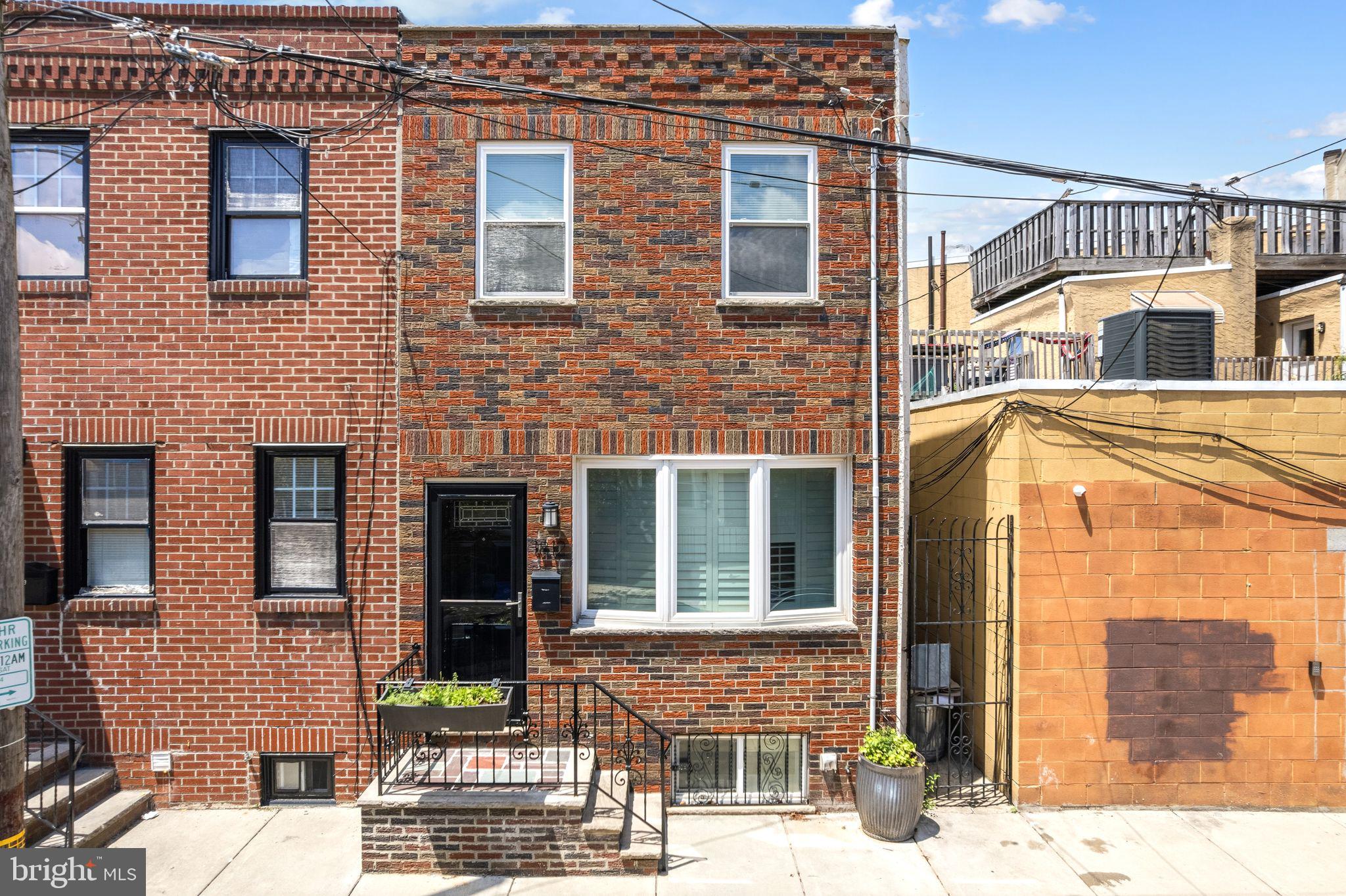Charmer on South Camac Street, just steps away from bustling Passyunk Avenue in the heart of Passyunk Square! This quintessential South Philly rowhome on a quiet block just off Passyunk Avenue is not only move-in ready but also offers a rare opportunity for qualified buyers to assume the sellers' FHA loan with a 3.25% (YES, 3.25%!) interest rate! Step through the penny tile entryway into the 14ft wide living room featuring gleaming hardwood floors, a large bay window with plantation shutters, a custom media cabinet, built-in speakers, recessed lighting, plus a dining area complete with a wood accent wall and a chandelier. The large eat-in-kitchen has been updated with quartz countertops, a deep sink, cherry wood cabinets, stainless steel appliances including a built-in microwave, and tile flooring. The rear patio provides a great space for al-fresco dining and provides access to the alley leading straight to the street. The main level also features a convenient half bath with fun details like shiplap walls and a fan. Upstairs you'll find three bedrooms plus a hall bath. The primary bedroom sits in the front of the home and features two windows, a ceiling fan, and a large closet. The middle hall bedroom also features a ceiling fan, and a window. The rear bedroom is the perfect home office space with two windows which allow natural light to shine through. The shared hall bathroom features a tub/shower combo with floor to ceiling tiles and a vanity with under-sink storage. The basement has been partially finished and houses the mechanicals, the washer/dryer, and is great for extra storage. Recent updates include a new boiler in 2025, new kitchen countertops and backsplash, new entryway tile, updated powder room, a new storm door, and more! Located in an unbelievable location, you are within steps of everything this great neighborhood has to offer. Enjoy being around the corner from neighborhood favorites including Barcelona Wine Bar, Stogie Joes, Stargazy, Cantina Los Caballitos, Sao, Rival Bros Coffee and much much more. Just a short walk to the ACME supermarket and easy access to public transit with multiple bus line and Tasker/Morris stop for the Broad Street Line. *Sellers have an FHA loan at 3.25% which is assumable, meaning a buyer can take over the loan terms for qualified buyers.*