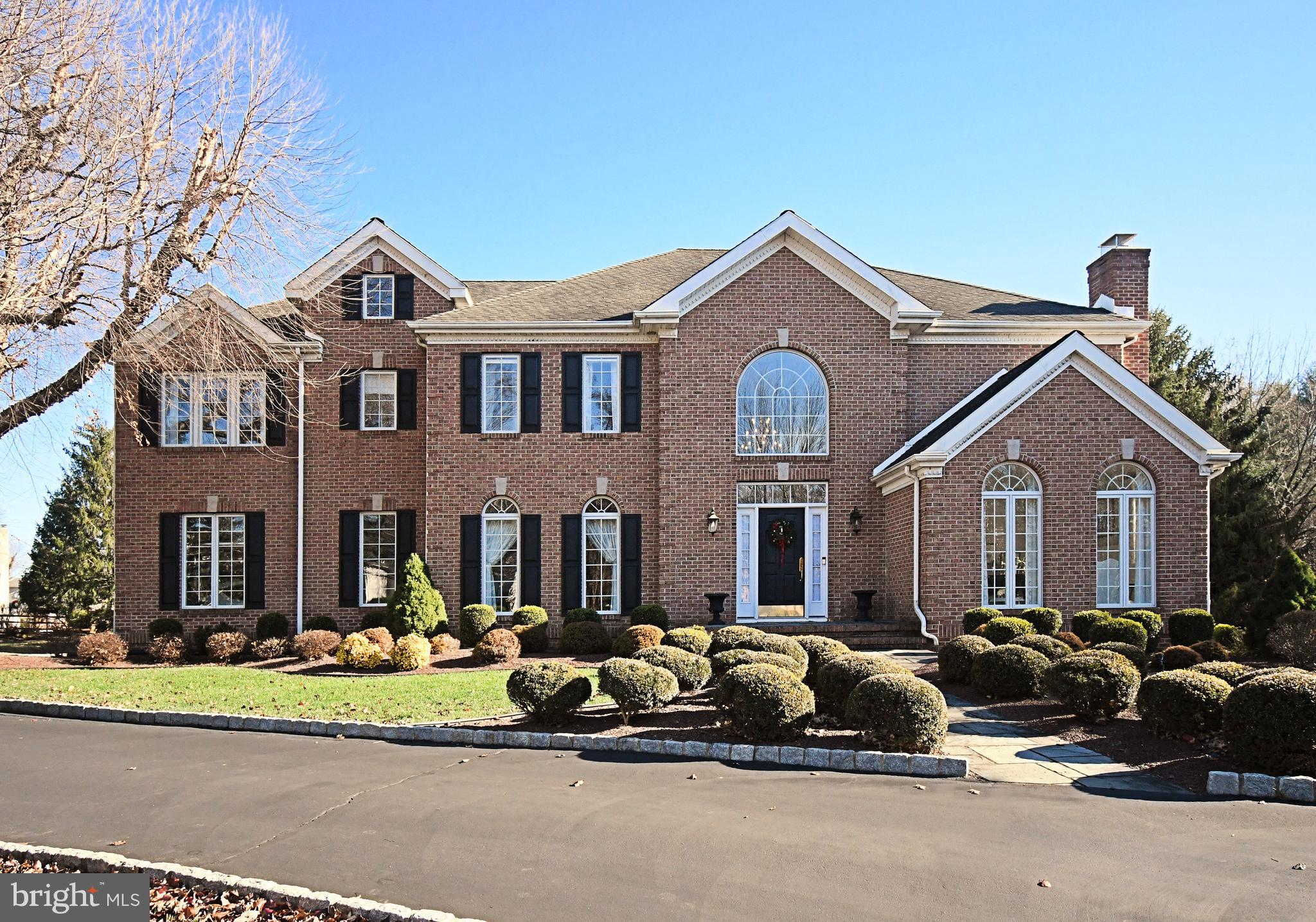 This stunning brick-front colonial with a 3 car side entry garage shows like a model home! Welcoming you with a grand 2 story foyer & gleaming hardwood floors. The formal living room impresses with a wood burning fireplace and volume ceiling, while the elegant dining room features upgraded millwork. A private study with French door entry offers custom built-ins the perfect work space. The spacious family room, highlighted by a wood burning brick fireplace and crown molding, opens to the rear grounds through an atrium door with transom above. Additionally, there is a wet bar, perfectly situated to entertain guests on the patio or around a warm fire during the cooler months!  The custom gourmet kitchen is a chef's dream, featuring raised panel white cabinetry, granite countertops, center island, desk area and upgraded stainless steel appliances including an Induction Cooktop.  Adjacent is a sun drenched breakfast room with a volume ceiling, skylights and a wall of windows overlooking the rear pool. There is access to the large rear covered patio perfect for outdoor entertaining.  Upstairs, this level features 5 spacious bedrooms including the Primary Suite with luxurious bath. The bath offers a soaking tub, vanities and walk in shower. The additional bedrooms are all generously sized, offering comfort and space for family or guests. There is a convenient 2nd floor laundry room and backstairs to the kitchen / breakfast room. Below is a full finished basement with game room, den, craft room, wet bar for entertaining, full bath with shower and an additional room perfect for office or additional bedroom. The grounds have been professionally manicured and landscaped  with fencing around the custom inground pool! There is a cabana house with kitchen, laundry, bathroom, and storage room.  Hours of entertainment can be enjoyed, this property will not disappoint!