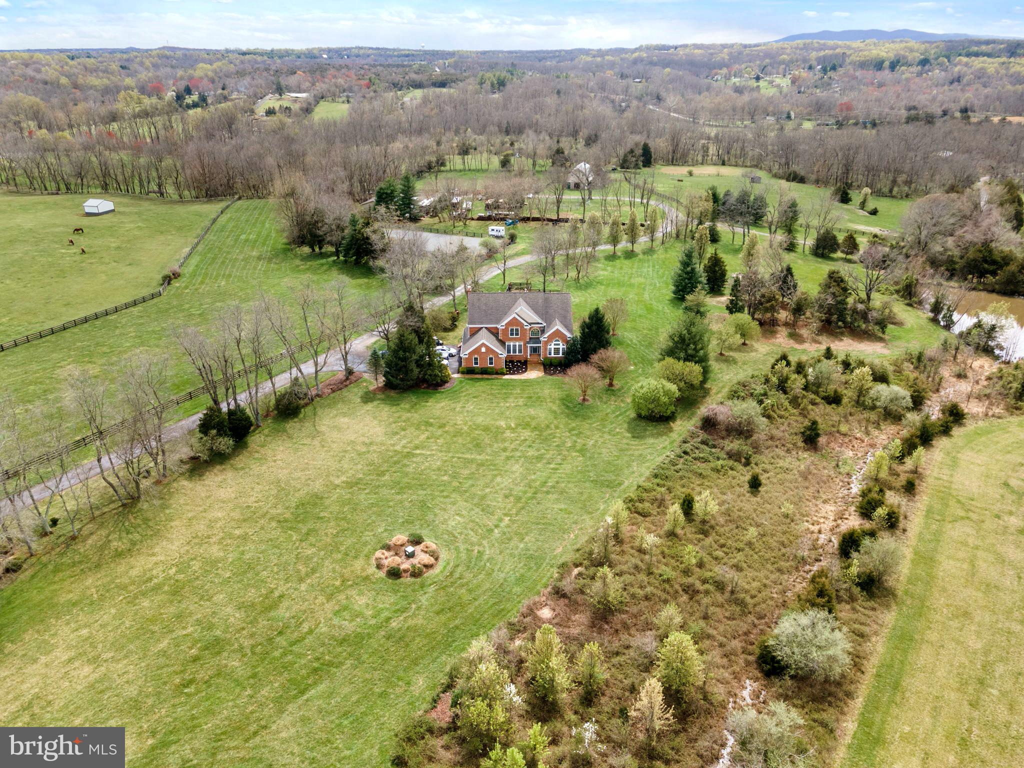 WOW!!  Talk about a  Price Improvement!  PondoRosa, a spectacular Sportsman's paradise in Leesburg!  Sited on over 50 acres on a conservancy lot in the community of Red Cedar, this beautiful home with almost 6000 sq ft sits on a perfect knoll  for views of the mountains, sunrises and sunsets, all  of which are absolutely stunning!!  This property is perfect for any level equestrian, farmer, or simply the most discerning buyer wanting the acreage AND proximity to Dulles Airport (20 minutes), Leesburg Airport(less than 10), the Greenway (10 min) and a 10 minute drive to Downtown Leesburg!  The home itself is move in ready with a giant gourmet kitchen, formal living and dining rooms, family room, den, and office as well as one full and one half bath on the main level.  The upper level boasts the primary suite with huge walk in closet and bath, three other large bedrooms and two full baths.  The lower level is perfect for the outdoorsman with a kitchen and bar, billiard room, full bedroom and bath, den with fireplace and tons of storage.    From the home, a short walk will lead you past a lovely stocked pond and around to to the classic center aisle barn.   The barn has six stalls including a wash stall, dry stall and tack room, full hay loft, and water.  Walkout to adjoining paddocks,  three additional run ins, two with water, one with water at the fence.  The Dressage riding ring measures 80 x 128, is blue stone and fenced.  Following the drive around past the  barn is the workshop which consists of  two oversized bay doors for equipment, an office which could be converted to grooms quarters, pad for RV's, and hook ups.   This incredible property also fronts Goose Creek.  Hunting, fishing, kayaking, trail rides, etc.  There is something for everyone at PondoRosa.