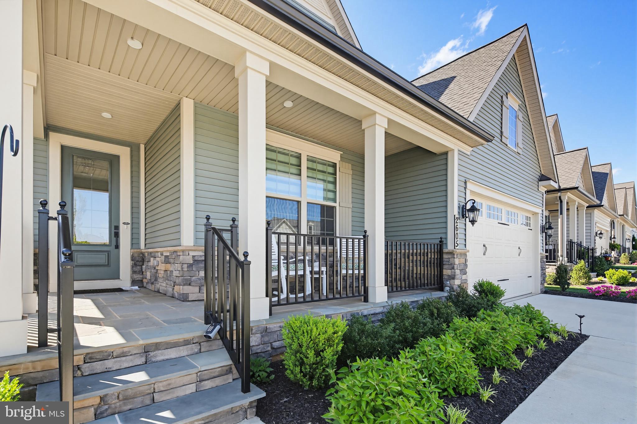 LIKE NEW WITHOUT THE WAIT!  $100,000 IN PREMIUM OPTIONS INCLUDED!  Welcome to 2605 Broadleaf Drive, an exceptional residence in Frederick’s highly sought-after Bloomfields 55+ community, where luxury, value, and immediate enjoyment come together beautifully. Unlike new construction opportunities that often require months of waiting along with substantial additional expenses for lot premiums and builder upgrades, this thoughtfully enhanced home is fully completed and move-in ready!  From the oversized homesite and extensive landscaping to the carefully selected finishes and elevated design features throughout, this exceptional property delivers the benefits of new construction without the delays, uncertainty, or escalating costs of building from the ground up.
Designed for both everyday comfort and elegant entertaining, this beautifully appointed 3-bedroom, 4-full-bath home offers refined living across three finished levels. Light-filled interiors, expansive open spaces, and sophisticated finishes create an atmosphere that feels both elevated and welcoming. Perfectly positioned on one of the largest lots in the community, the property also offers a beautifully landscaped outdoor retreat designed for peaceful relaxation as well as effortless entertaining.
The main level showcases an expansive open-concept layout where the living, dining, and kitchen spaces flow seamlessly together. At the center of the home, an oversized island creates the perfect gathering place for family and friends, while sparkling white cabinetry, elegant quartz countertops, and sleek stainless steel appliances bring both style and function to the beautifully designed kitchen. Large windows fill the home with natural light as the space continues into the spacious living room, anchored by an elegant fireplace that adds warmth and character.
Just beyond, the screened-in covered porch extends the living space outdoors and opens to a custom patio and beautifully landscaped backyard retreat, a rare offering within the community and part of the extensive investment the current owners made to elevate the home well beyond standard builder specifications. Whether enjoying morning coffee, quiet evenings, or entertaining guests, the outdoor living spaces were thoughtfully designed to be both beautiful and functional.
Also located on the main level are two generously sized bedrooms, including the luxurious primary suite, which continues the home’s bright and airy feel. The spacious bedroom features two large walk-in closets and a spa-inspired bath complete with dual vanities and a large walk-in shower with dual shower heads. Just outside the suite, the conveniently located laundry room adds ease to everyday living, while the mudroom area provides direct access to the two-car garage. Toward the front of the home, the second main-level bedroom offers a large closet and convenient access to a full bathroom, creating an ideal space for guests or a home office.
Upstairs, a versatile loft provides the perfect setting for a family room, reading lounge, hobby area, or additional gathering space. The third bedroom offers comfort and privacy with a spacious walk-in closet, while an additional full bath and dedicated storage area complete the upper level.
The finished lower level offers expansive flexible living space ideal for entertaining, game nights, movie watching, or extended guest stays. A full bathroom and large unfinished storage area further enhance the functionality of this impressive lower level.
Beyond the home itself, Bloomfields offers an exceptional resort-style lifestyle thoughtfully designed around approximately 15 acres of scenic parkland and walking trails. Residents enjoy access to a beautifully appointed clubhouse featuring a fitness center, pools, tennis courts, pickleball courts, a putting green, inviting outdoor fireplace areas, and a community herb garden with potting shed.