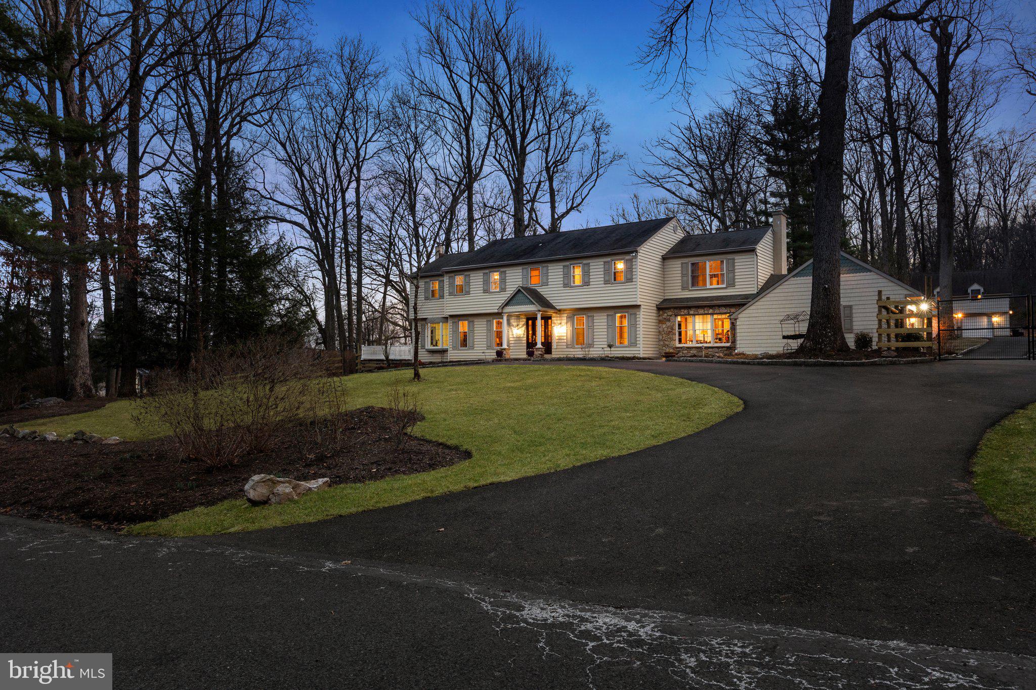 Nestled on 2.5 acres of serene countryside, this  remodeled, custom home along with it's separate Guest House, combines luxurious living with the peaceful beauty of nature. Surrounded by breathtaking views, the property offers the perfect balance of space, comfort, and style. A circular driveway leads you up to this stunning home, perched gracefully on a hill. As you enter through the elegant new mahogany front door, you’re greeted by a grand foyer with gleaming hardwood floors, intricate wainscoting, and custom wood trim throughout.

The heart of the home is the newly renovated kitchen, designed with the highest quality finishes. Quartzite countertops, maple cabinetry, a grand island, double ovens, and a 5-burner electric cooktop with downdraft provide the ideal space for cooking and entertaining. The adjoining family room addition is a true highlight, featuring a floor-to-ceiling stone wood-burning fireplace, Anderson doors leading to the deck and patio, skylights, ceiling fans, and panoramic views of the lush yard and stunning sunsets.

This home’s first floor offers a variety of elegant spaces including a library with its own wood-burning fireplace, a formal dining room, a cozy living room, a sunroom with southern exposure, a music conservatory with built-in shelving and a separate entrance to a no-maintenance deck, and two mudrooms for ultimate convenience.

Upstairs, the redesigned layout includes a spacious laundry room with custom cabinetry and 4 generously sized bedrooms. The primary suite offers a large sitting room, a newly remodeled bath with radiant heated flooring, and a walk-in closet with built-in storage. The three additional bedrooms are equally spacious, each featuring expansive closets with organizers, ceiling fans, and hardwood floors.

The home underwent a thoughtful remodel in 2008, which included the family room addition, new windows and doors, and an updated laundry room. A partially finished basement provides additional space for a game room or extra storage. The attached 3-car garage offers side entry for added convenience.

A standout feature of the property is the carriage house/guest house, which includes a cozy one-bedroom suite with its own kitchenette, living room, and a heated and air-conditioned 2-car garage — perfect for guests or additional living space.
New Hope's Gem!
