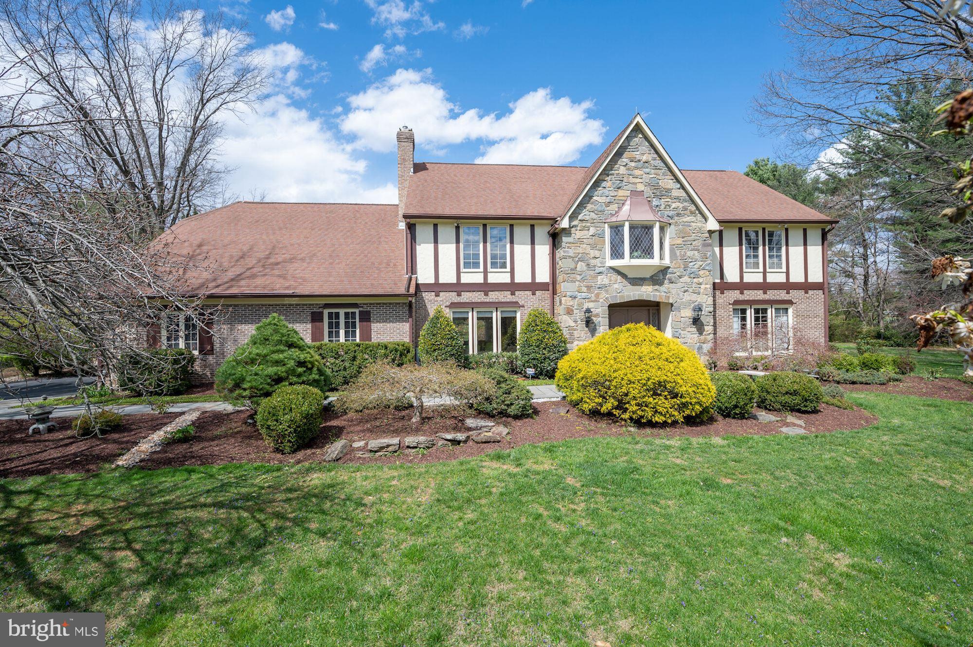 **OFFERS DUE BY 12 PM, TUESDAY, 4/26** Welcome to 10601 Tanager Lane, a handsome Tudor style home perfectly sited on a scenic two-acre lot in Glen Mill Knolls. Boasting over 7,000 square feet on 3 levels, this residence exudes elegance with its attention to fine details. The Main Level’s open floor plan and upgraded finishes include beautiful hardwood flooring and custom millwork. The grand 2-story Foyer complete with a modern glass chandelier welcomes you to this beautiful abode. The Foyer opens to the formal Living leading to a banquet-sized formal Dining Room. The Main Level also hosts an expansive gourmet Kitchen with gleaming granite counters, modern tiled backsplash, island with an attached breakfast bar and newer stainless steel appliances. The Kitchen features a fabulous Breakfast Area boasting a custom-built banquette, abundant pantry and utility storage, and French doors that lead to the expansive slate patio. An oversized Family Room with gas fireplace with stone surround and adjacent full stand-behind Bar and a Handsome Office complete the Main Level’s entertainment offerings. A generous Laundry Room with plenty of work and storage space and an oversized attached 2-Car Garage round out the ample amenities the Main Floor has to offer. An elegant, curved staircase leads to the Upper Level that features a bay window and viewing gallery above the Foyer. The Primary Suite boasts a spacious Bedroom open to a cozy Sitting Room, large En-Suite Dressing Room, complete with custom built-in dressers, and an oversized walk-in Primary Closet. The En-Suite Primary Bath features marble tile floors, dual vanity, Jacuzzi tub, stall shower, sauna, heat lamp, linen closet and walk-in storage closet. The Upper Level also offers 3 additional Bedrooms, each with abundant closet space and recessed lighting, and 2 Full Bathrooms. The Lower-Level is the perfect space for guests or family with a Recreation Room, Full Kitchen, a Guest Room and Full Bath. The Lower Level also features newly installed carpeting and ample storage space along with a walk-in cedar closet.  The outdoor amenities of this private two-acre property shine with professional landscaping and hardscaping, as well as a lily pond and two-level fish pond with waterfall, to make the most of your leisure  time in this peaceful setting! 
3 ZONE HVAC, NEW 75 GAL HOT WATER HEATER 2022, NEW HARDWOOD FLOORS IN LIVING & DINING ROOMS 2022, NEW LOWER LEVEL CARPET 2022, NEW LOWER LEVEL HEAT PUMP 2021, NEW COOKTOP, DOUBLE OVENS & DISHWASHER 2021, NEW CARPET IN UPPER LEVEL SECONDARY BEDROOMS 2021, NEW HVAC MAIN & UPPER LEVELS 2013, HARDWOOD UNDER CARPET IN FAMILY ROOM, OFFICE AND THROUGHOUT UPPER LEVEL, 9' CEILINGS ON THE MAIN LEVEL
