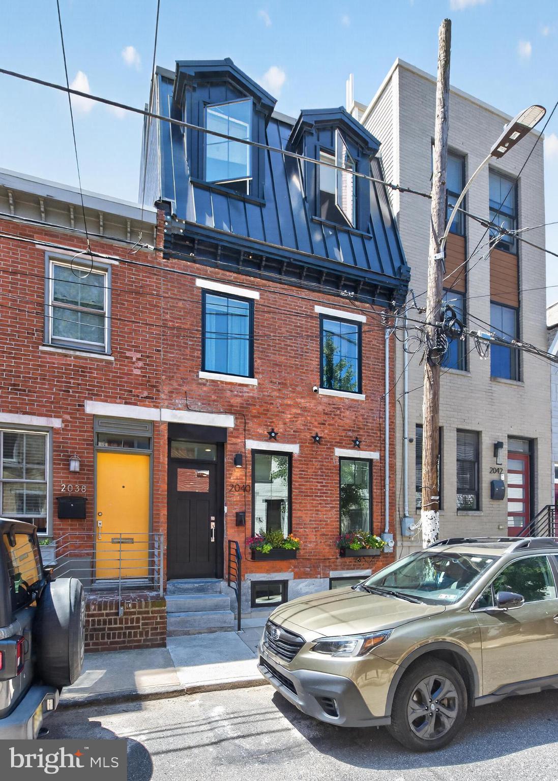 Welcome to 2040 Pemberton Street, a stunning brick-front row home with exceptional curb appeal in the heart of Graduate Hospital. Thoughtfully designed with a full-floor primary suite, this sophisticated residence offers 3 bedrooms, 3 full bathrooms, a finished basement, beautifully renovated outdoor living spaces, and a remaining 5-year tax abatement.

The sun-filled main level features striking herringbone flooring, recessed LED lighting, and an open-concept layout ideal for both everyday living and entertaining. The chef's kitchen serves as the centerpiece of the home, showcasing two-tone flat-panel cabinetry, super-white quartzite countertops, premium Bertazzoni stainless steel appliances, and direct access to a spacious rear patio. Complete with a dedicated gas line for grilling, this outdoor space is perfectly suited for effortless al fresco dining and entertaining.

A custom steel stringer staircase with solid oak treads and an exposed brick accent wall leads to the second floor, where two generously sized bedrooms feature custom-built closet systems designed to maximize storage and organization. A full bathroom and convenient laundry room complete the level.

Occupying the entire third floor, the luxurious primary suite offers a spacious bedroom, dual walk-in closets with custom built-ins, and a spa-inspired bathroom featuring dual floating vanities, a frameless glass-enclosed wet room with multiple shower fixtures, a freestanding soaking tub, and elegant designer finishes throughout.

Crowning the home is a spectacular, newly renovated rooftop retreat designed for both entertaining and relaxation. Featuring premium Ipe wood decking, low-maintenance artificial turf, and a custom bar with stone countertops, this outdoor oasis delivers breathtaking 360-degree city views and a direct, unobstructed view of the Philadelphia skyline. Whether hosting friends for sunset cocktails or enjoying a quiet morning coffee, this rooftop space is truly one of the home's most impressive features.

The fully finished lower level offers exceptional flexibility with ample space for a home office, fitness area, media room, guest suite, or additional living space, complemented by a third full bathroom.

Additional highlights include Pella windows, dual-zone HVAC, a tankless water heater, a new curb trap, and custom closet systems throughout. With an exceptional Walk Score of 98, this location places you just moments from Rittenhouse Square, South Street, University City, Penn, CHOP, and many of Philadelphia's most acclaimed restaurants, cafes, and neighborhood amenities.

Offering modern luxury, thoughtful design, and outstanding indoor-outdoor living in one of Philadelphia's most desirable neighborhoods, 2040 Pemberton Street is city living at its finest.